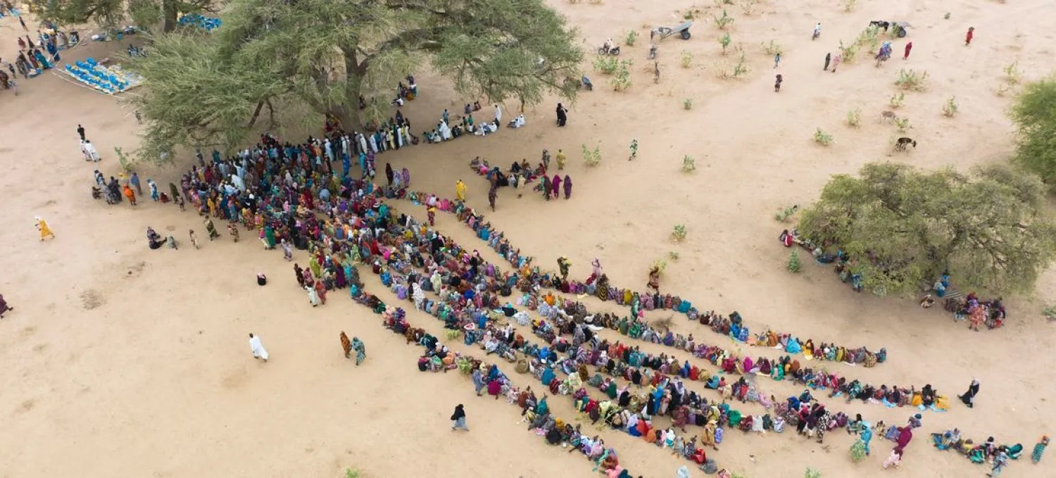 People displaced by conflict in Sudan queue for aid on arrival in Chad (UN)
