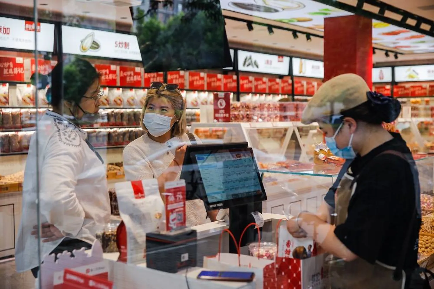 People shop in a food store in Beijing, China, 09 May 2023. (EPA) 