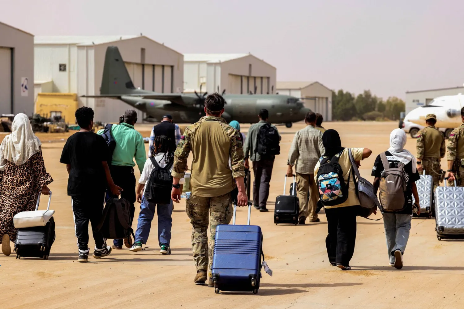 British nationals walk to board an RAF aircraft, during the evacuation to Cyprus, at Wadi Seidna Air Base in Sudan April 27, 2023. Phot Arron Hoare/UK MOD/Handout via REUTERS