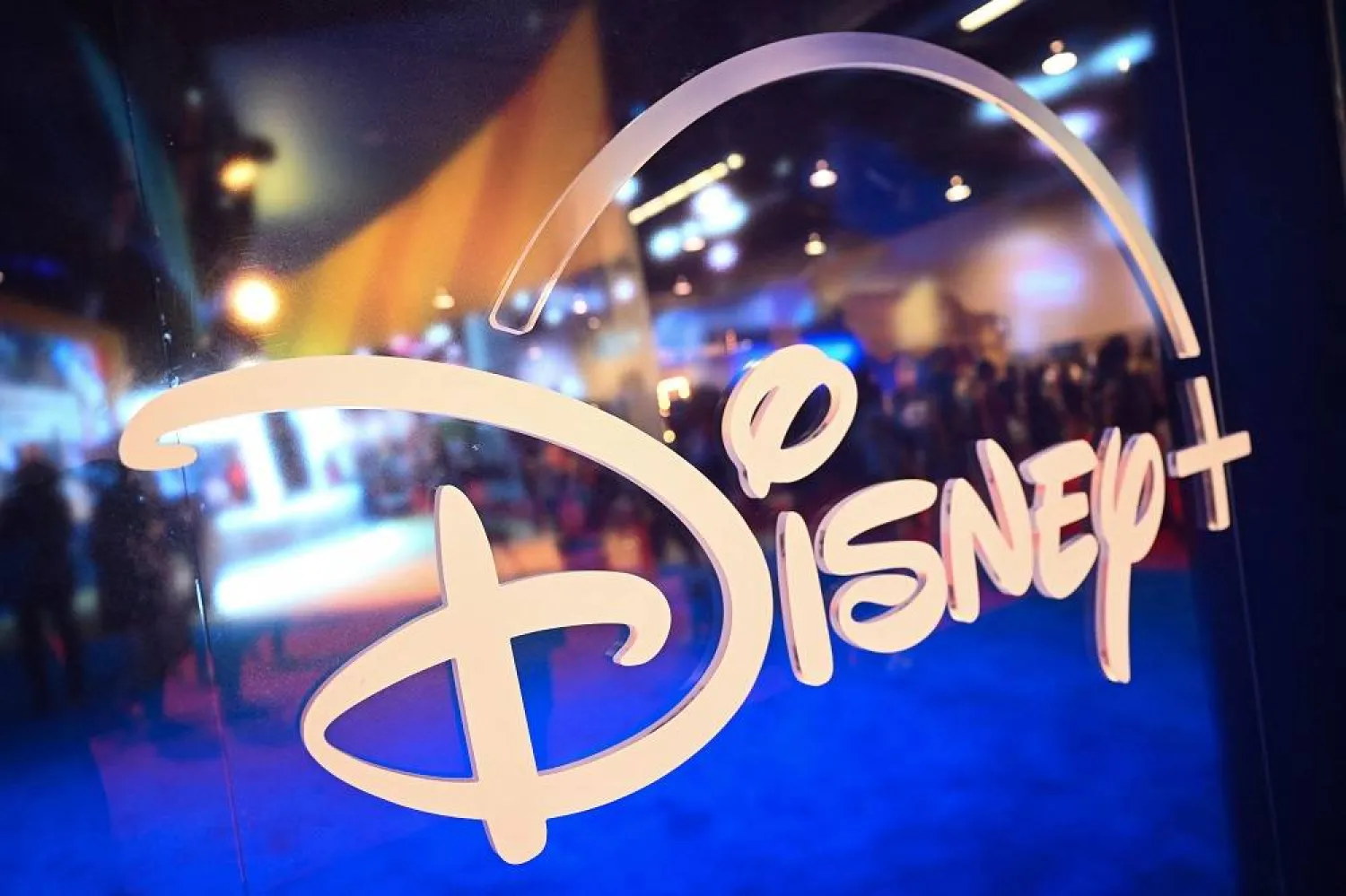 his file picture taken on on September 9, 2022 shows fans are reflected in Disney+ logo during the Walt Disney D23 Expo in Anaheim, California. (AFP)