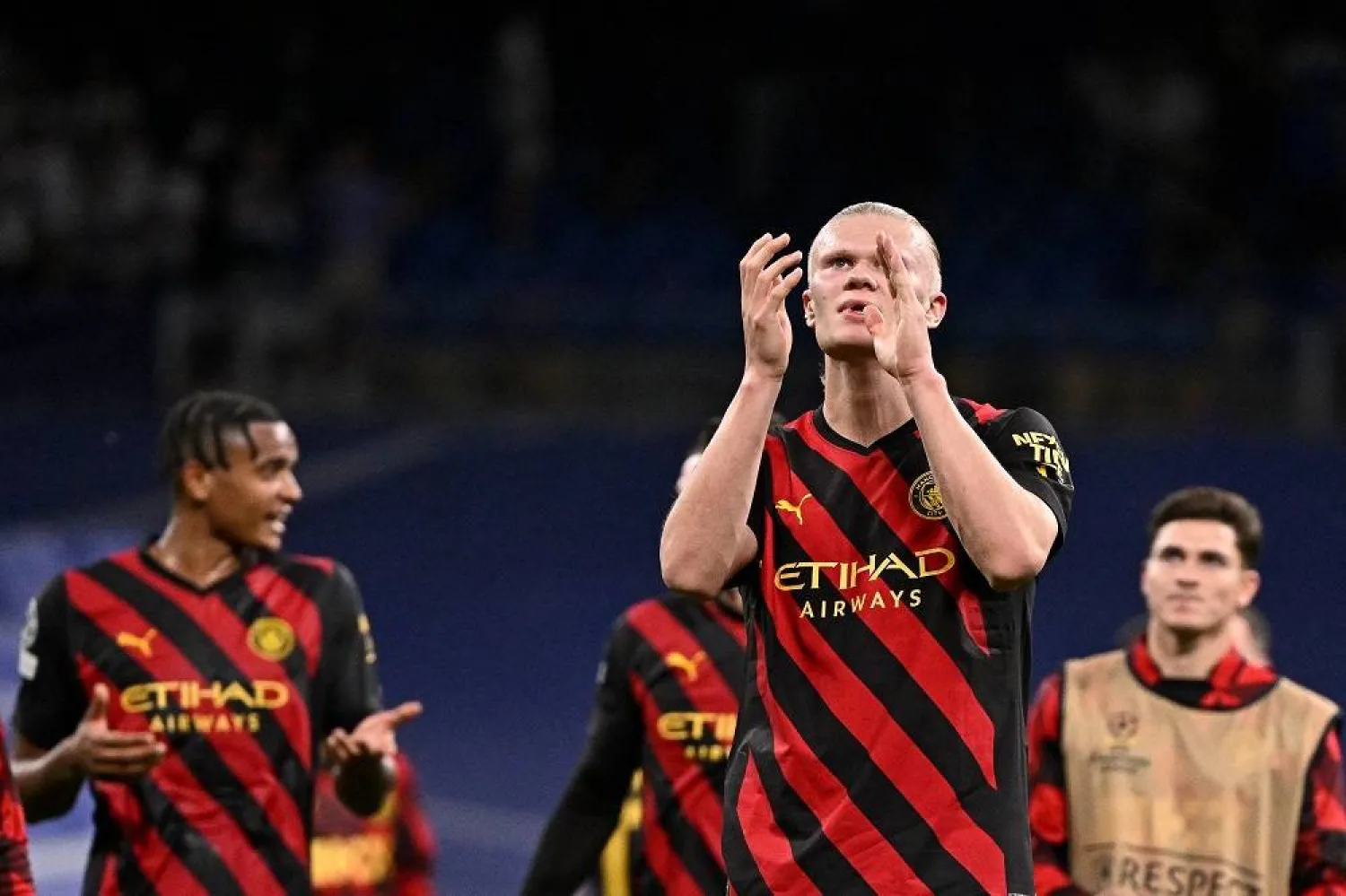 Manchester City's Norwegian striker Erling Haaland (R) and teammates applaud at the end of the UEFA Champions League semi-final first leg football match between Real Madrid CF and Manchester City at the Santiago Bernabeu stadium in Madrid on May 9, 2023. (AFP) 
