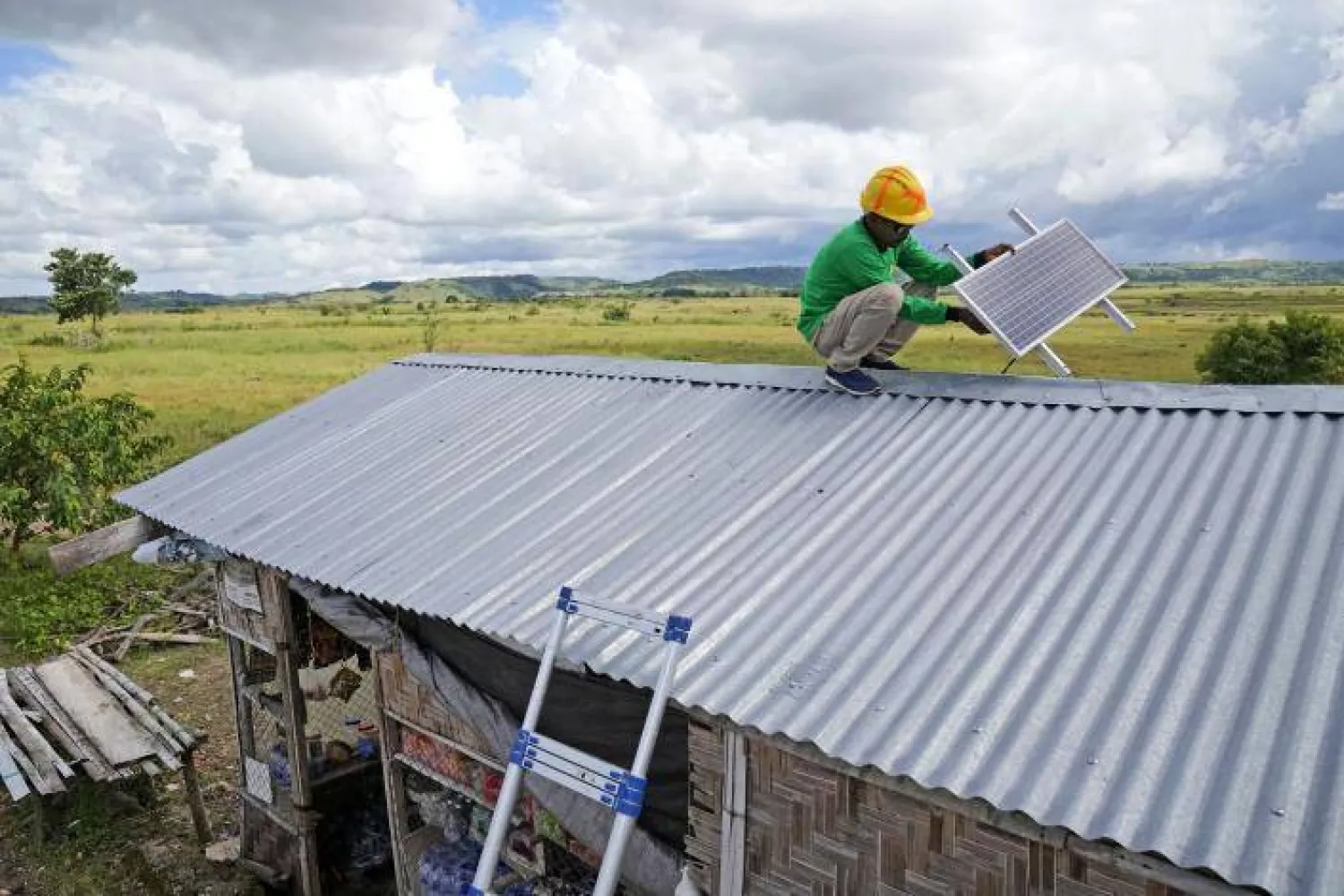 Antonius Makambombu, a worker of Sumba Sustainable Solutions performs maintenance work on a solar panel on the roof of a customer's shop in Laindeha village on Sumba Island, Indonesia, Wednesday, March 22, 2023. (AP Photo/Dita Alangkara)ASSOCIATED PRESSLess
