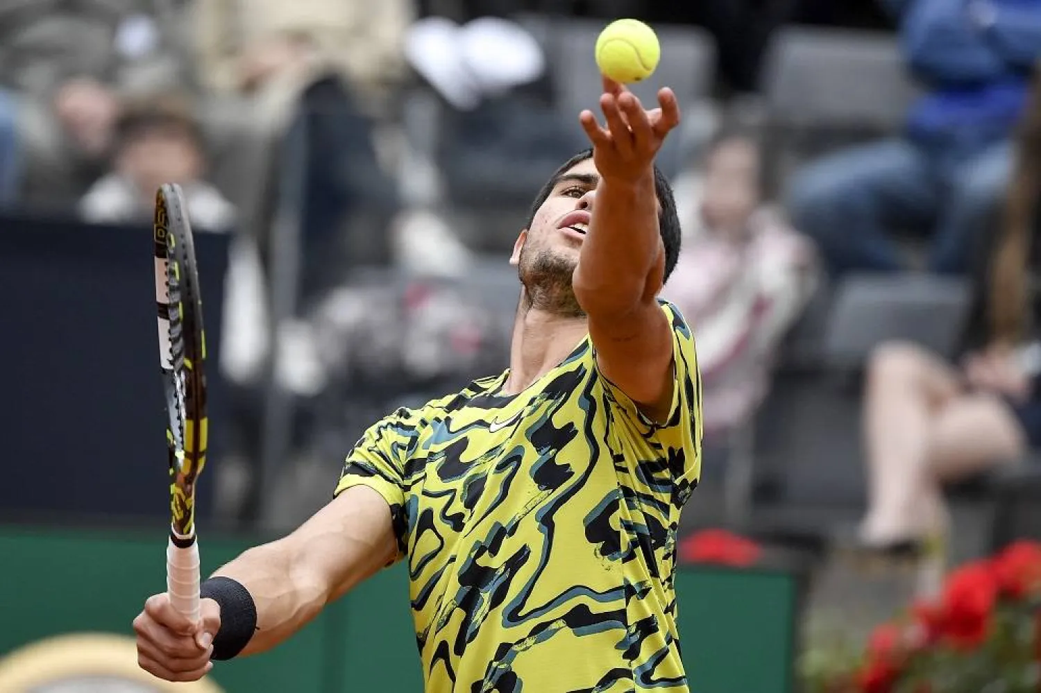 Carlos Alcaraz of Spain serves to Albert Ramos-Vinolas of Spain during their match at the Italian Open tennis tournament, in Rome, Saturday, May 13, 2023. (AP) 