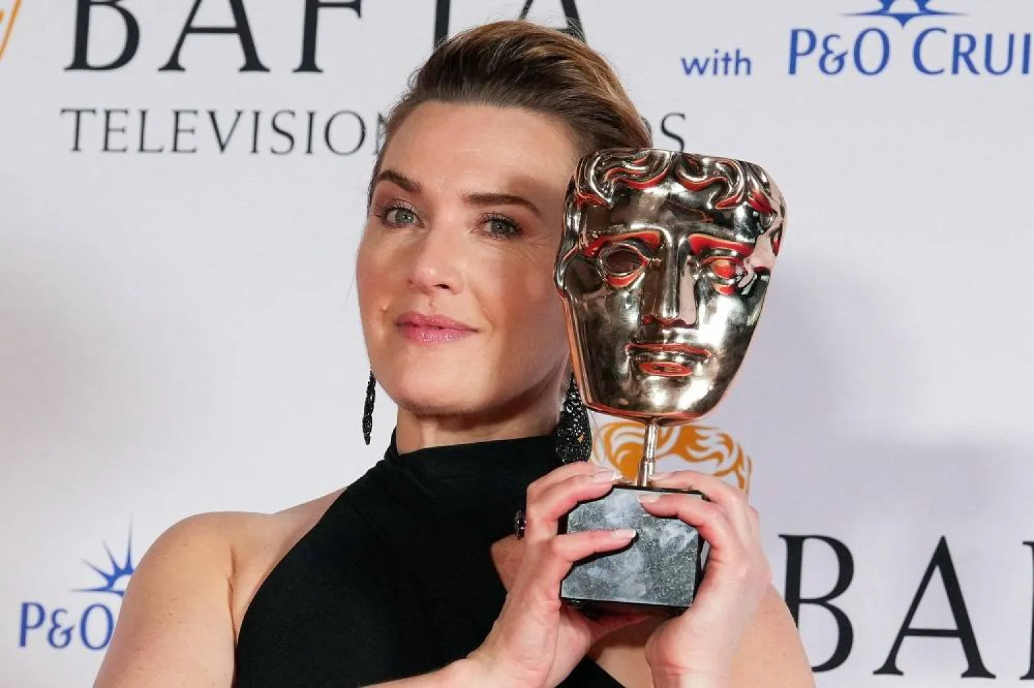 Kate Winslet, winner of the Leading Actress for “I Am Ruth” and the Single Drama Award for “I Am Ruth” poses with her award at the 2023 BAFTA Television Awards in London, Britain May 14, 2023. (Reuters) 