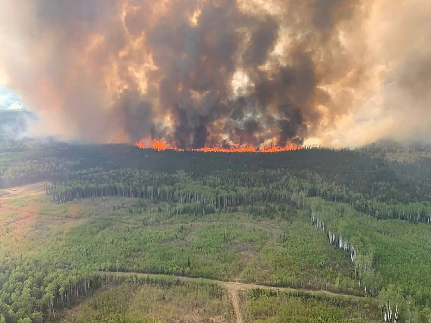 Smoke rises from the Bald Mountain Fire GWF 019 in the Grande Prairie Forest Area near Grande Prairie, Alberta, Canada May 12, 2023. (Alberta Wildfire/Handout via Reuters) 