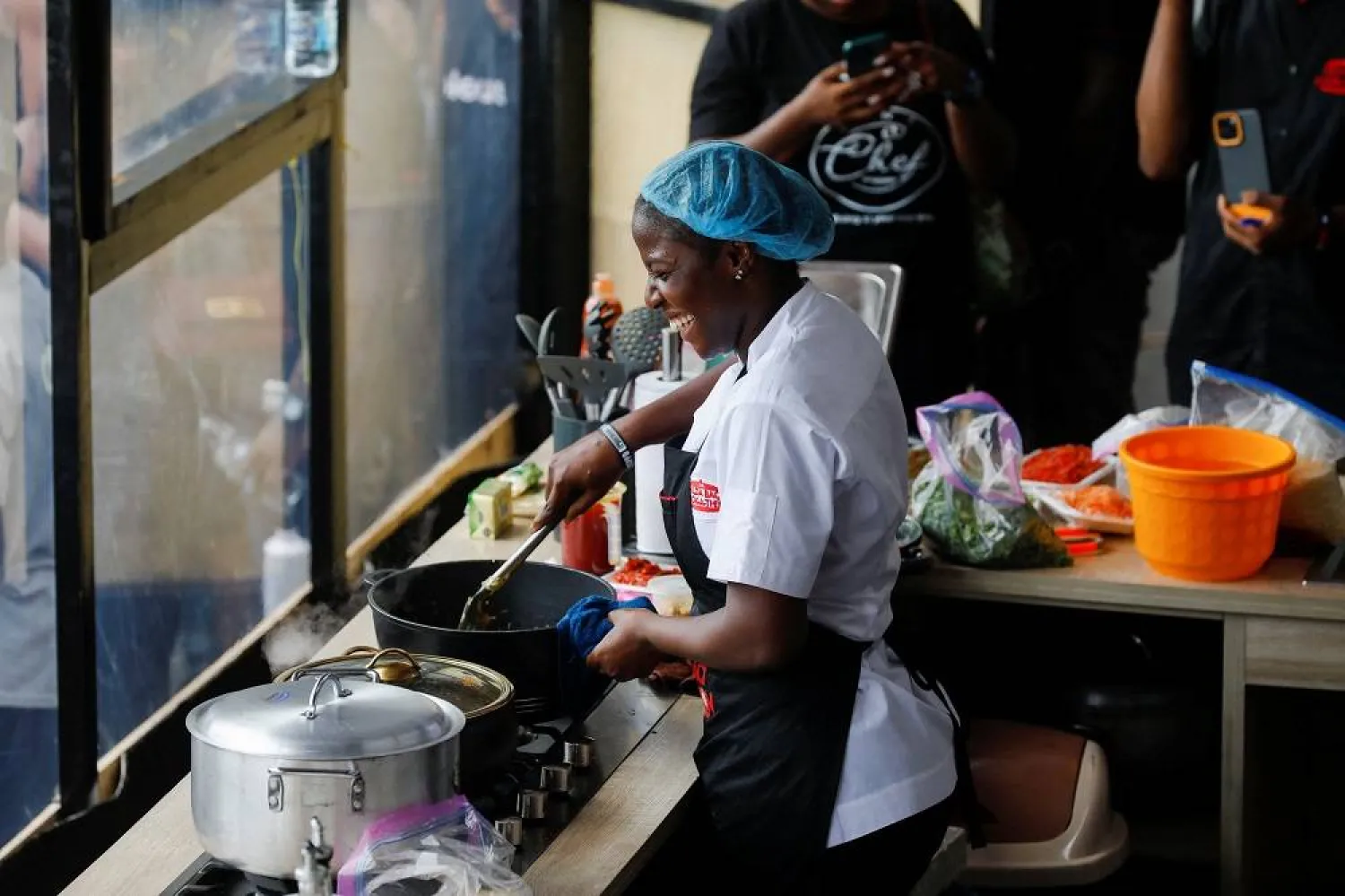 Nigerian Chef Hilda Bassey, 27, attempts to break the Guinness World Record for the longest cooking time by an individual, in Lagos, Nigeria May 15, 2023. (Reuters) 