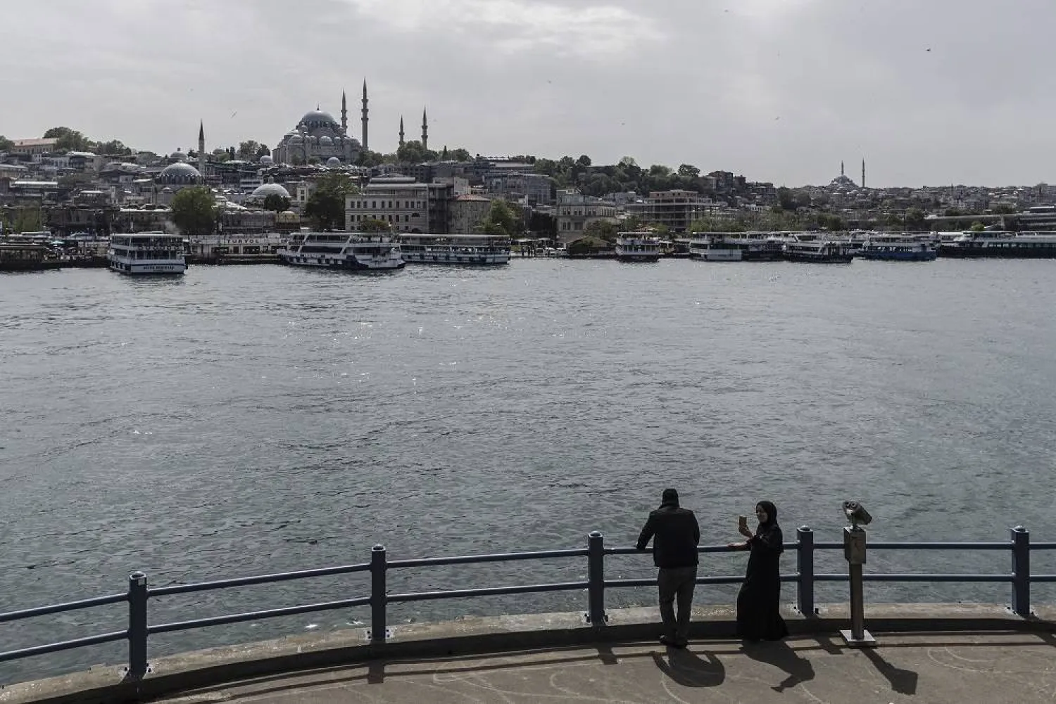 People enjoy the view from the Galata Bridge, backdropped by the Suleymaniye Mosque, two days after the general elections, in Istanbul, Türkiye, 16 May 2023. (EPA) 