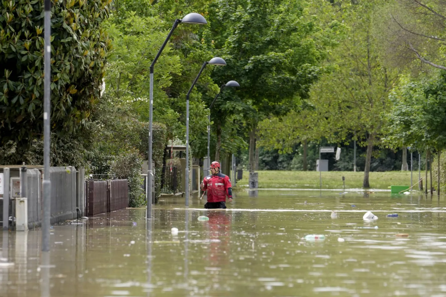 A rescuer walks in a flooded road in Faenza, Italy, Thursday, May 18, 2023. (AP Photo/Luca Bruno)