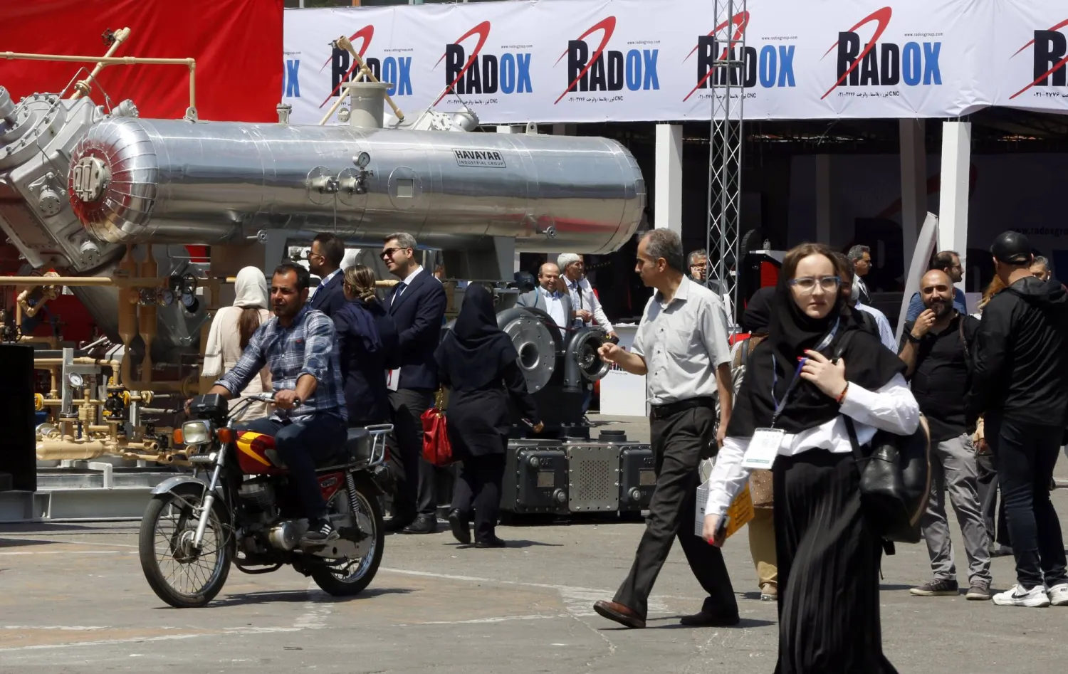 Visitors and employees attend the 27th Iran International Oil, Gas, Petrochemical exhibition in Tehran, Iran, 17 May 2023.  EPA/ABEDIN TAHERKENAREH