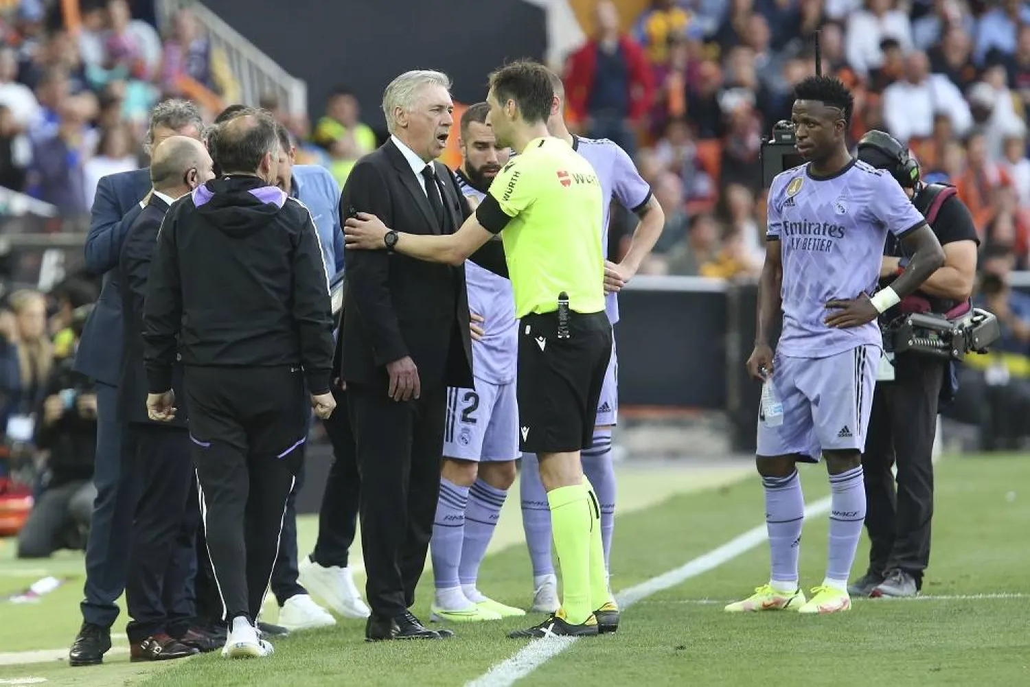 Real Madrid's head coach Carlo Ancelotti remonstrates with referee Ricardo De Burgos Bengoetxea as Real Madrid's Vinicius Junior looks on during a Spanish La Liga match between Valencia and Real Madrid, at the Mestalla stadium in Valencia, Spain, Sunday, May 21, 2023. (AP) 