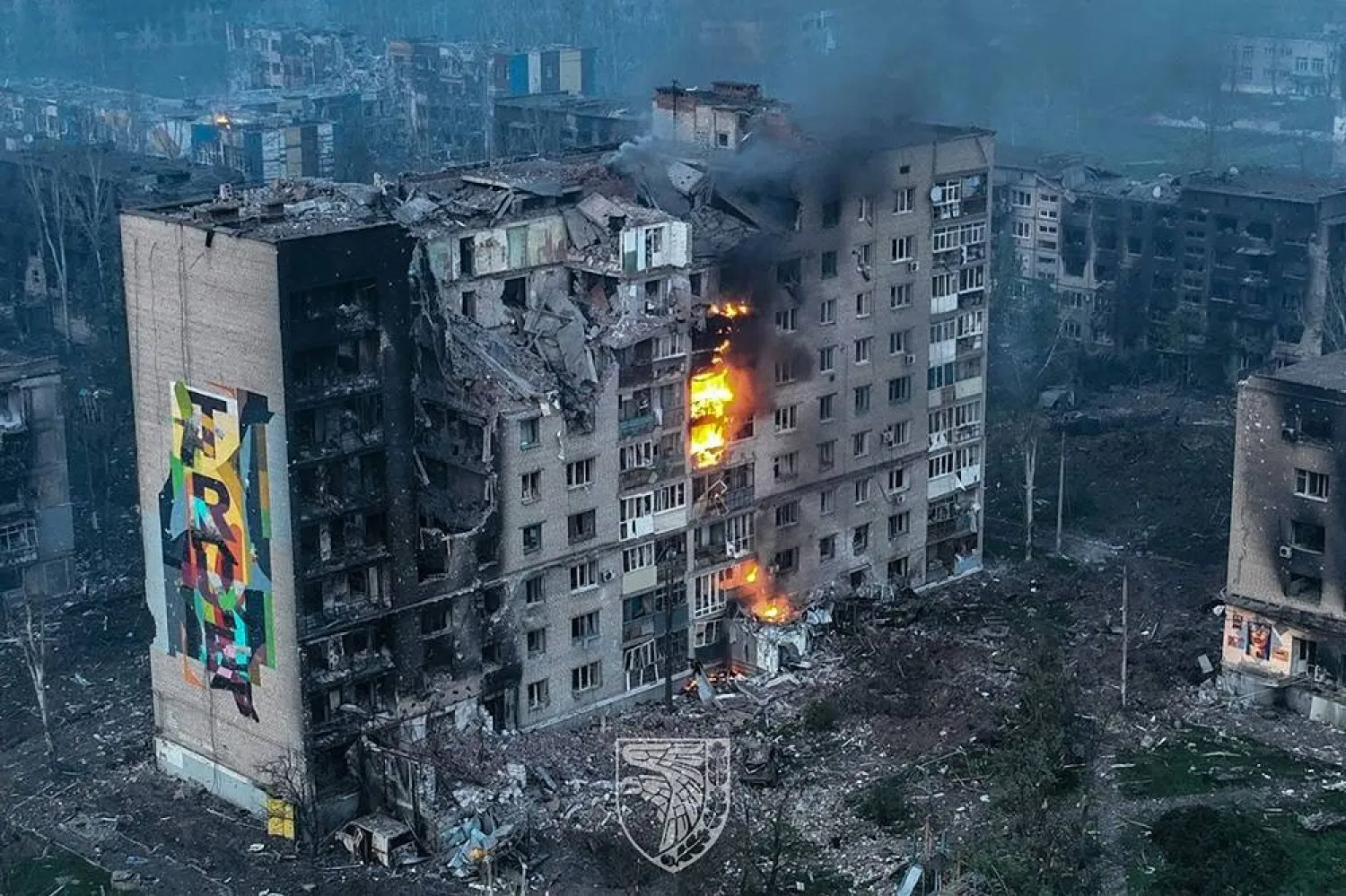 This undated handout aerial footage released on May 21, 2023, by the press service of the 93rd Kholodnyi Yar Mechanized Brigade of the Ukrainian Armed Forces shows an apartment block on fire in the city of Bakhmut, Donetsk region, amid the Russian invasion of Ukraine. (Handout / Armed Forces of Ukraine / AFP) 