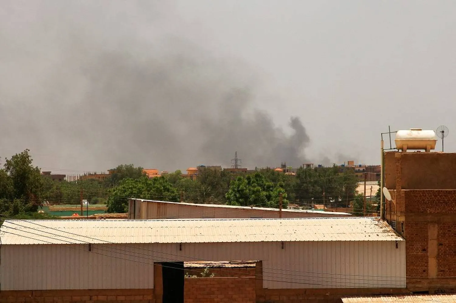 Smoke billows in the distance in Khartoum on May 22, 2023, as fighting between two rival generals persists. (AFP) 