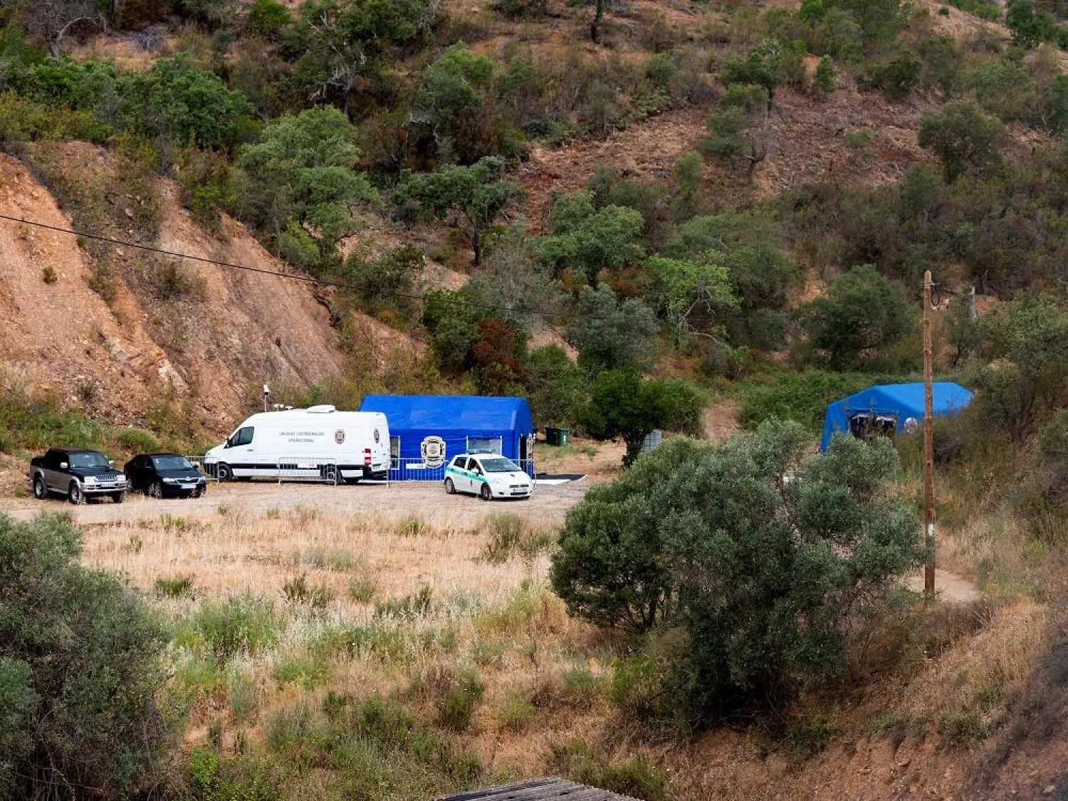 Vehicles and tents of Portugal's investigative Judicial Police are seen at the site of a remote reservoir where a new search for the body of Madeleine McCann is set to take place, in Silves, Portugal, in this screen grab from a video, May 22, 2023. (Reuters) 