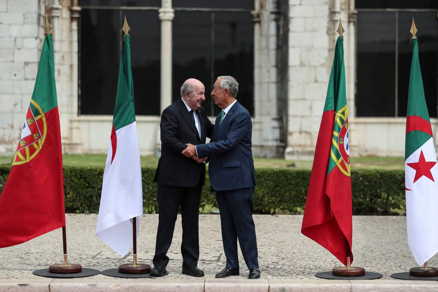 الرئيس البرتغالي مستقبلاً نظيره الجزائري لحظة وصوله إلى القصر الرئاسي بلشبونة (أ.ف.ب)