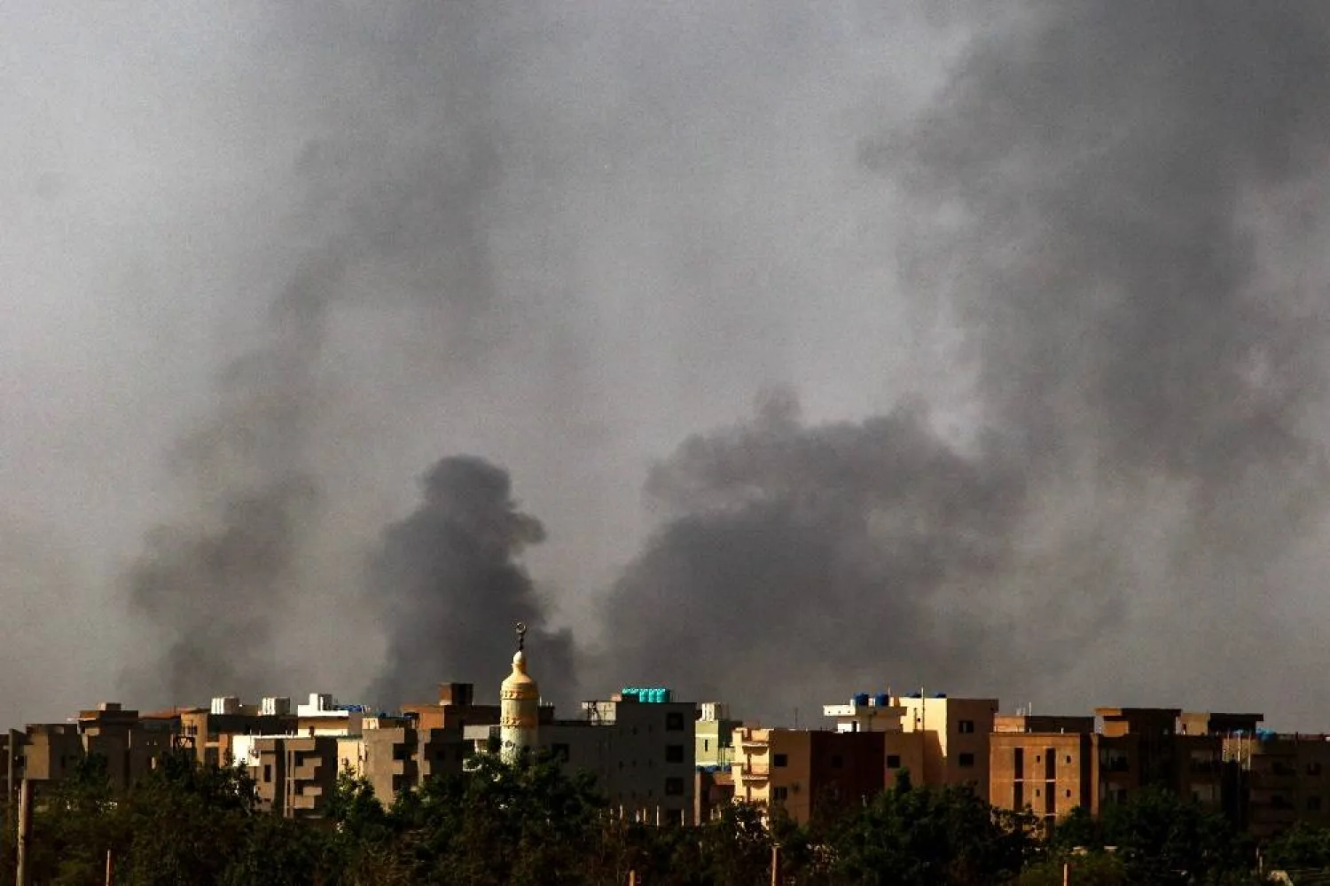 Smoke rises above buildings in Khartoum on May 24, 2023. (AFP) 