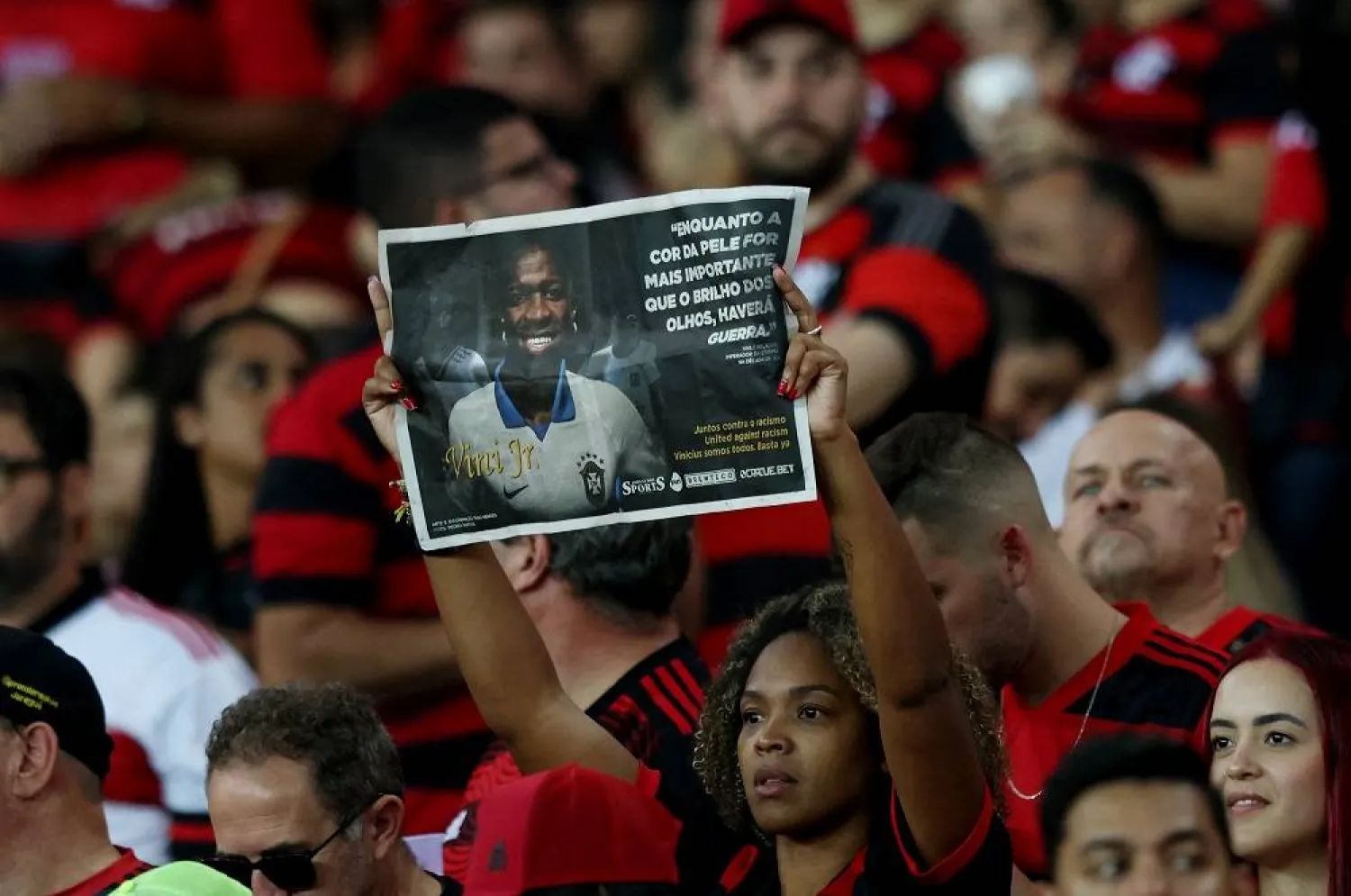 Football - Brasileiro Championship - Flamengo v Cruzeiro - Estadio Maracana, Rio de Janeiro, Brazil - May 27, 2023 A Flamengo fan displays an image of Vinicius Junior in support against racism before the match. (Reuters)