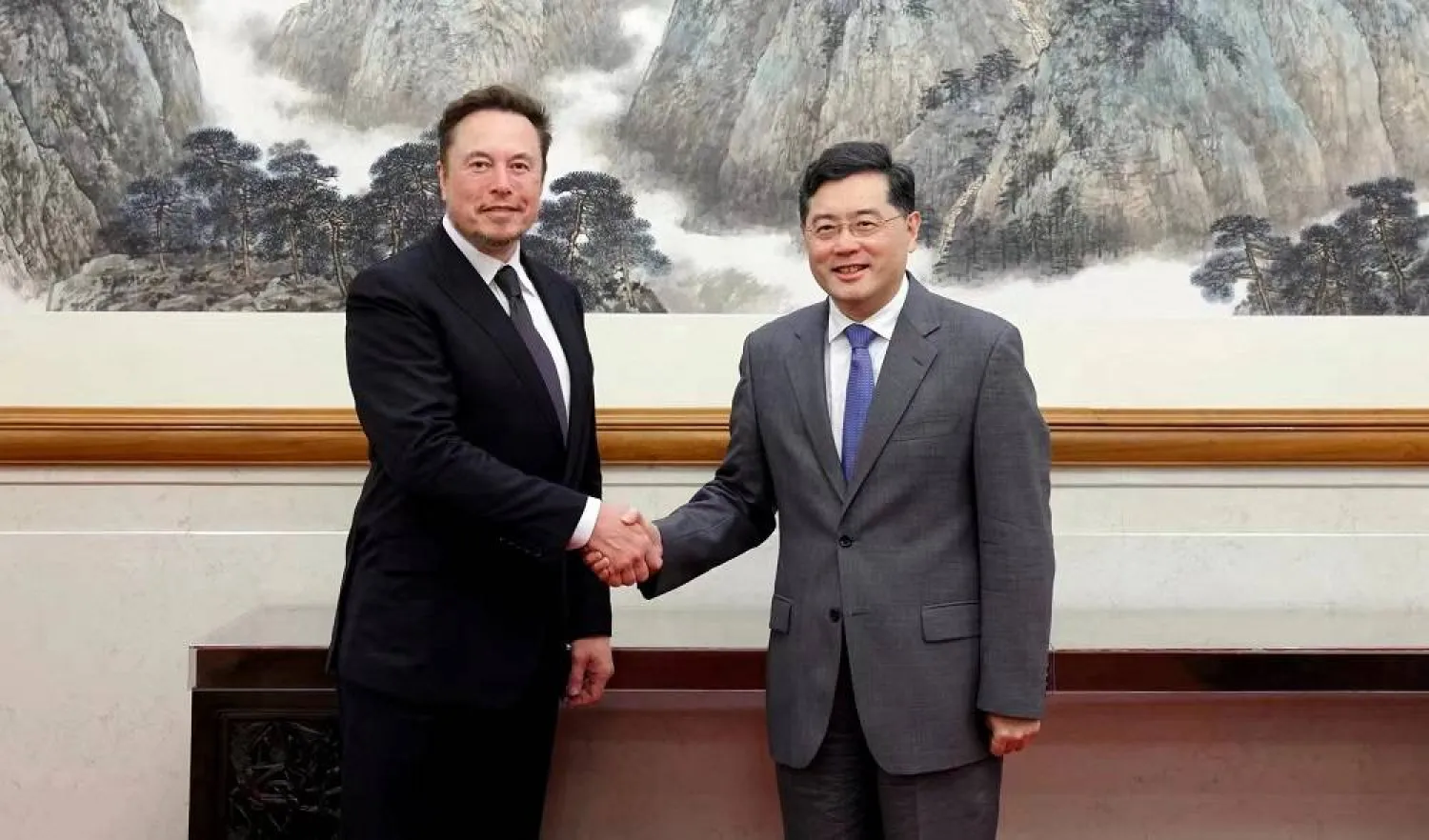 Chinese State Councilor and Foreign Minister Qin Gang meets Tesla Chief Executive Officer Elon Musk in Beijing, China, in this handout image released by China's Ministry of Foreign Affairs May 30, 2023. (China's Ministry of Foreign Affairs/Handout via Reuters) 