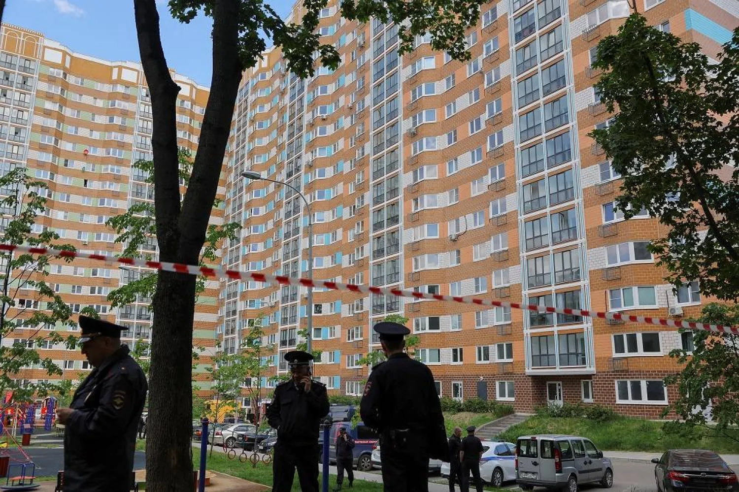 Russian law enforcement officers stand guard near a damaged multi-storey apartment block following a reported drone attack in Moscow, Russia, May 30, 2023. (Reuters) 