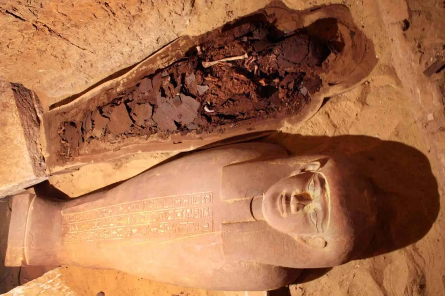 The remains of an Egyptian mummy and its
sarcophagus lie within a tomb at Saqqara, south of Cairo. AP