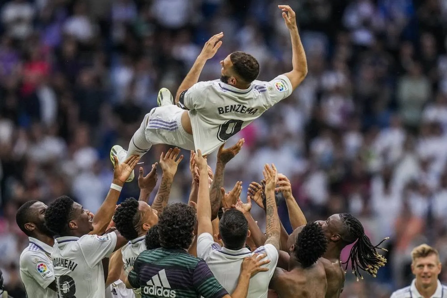Real Madrid's Karim Benzema is thrown in the air by teammates after their Spanish LaLiga match against Athletic Bilbao at the Santiago Bernabeu stadium in Madrid, Sunday, June 4, 2023. (AP) 