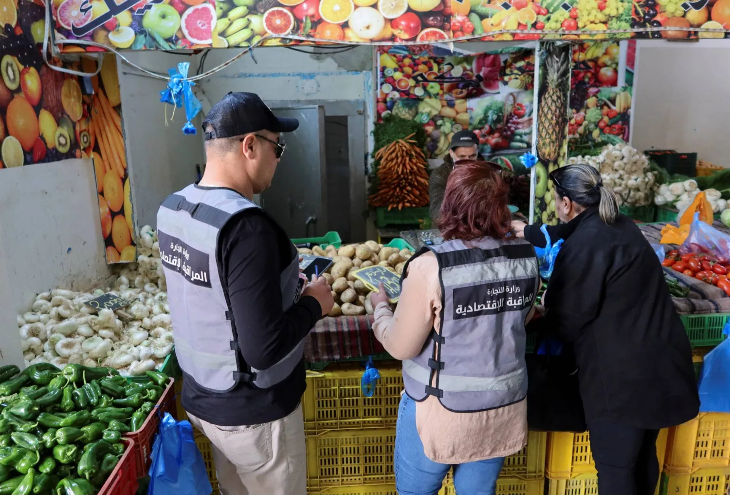 مفتشو الشؤون الاقتصادية بوزارة التجارة التونسية يراقبون سوقاً شعبية في بن عروس خلال شهر رمضان بتونس 29 مارس 2023 (رويترز)