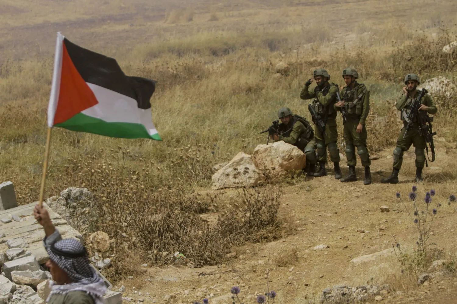 02 June 2023, Palestinian Territories, Beit Dajan: Israeli security forces take position during a protest by Palestinians against the establishment of Israeli outposts. (dpa) 