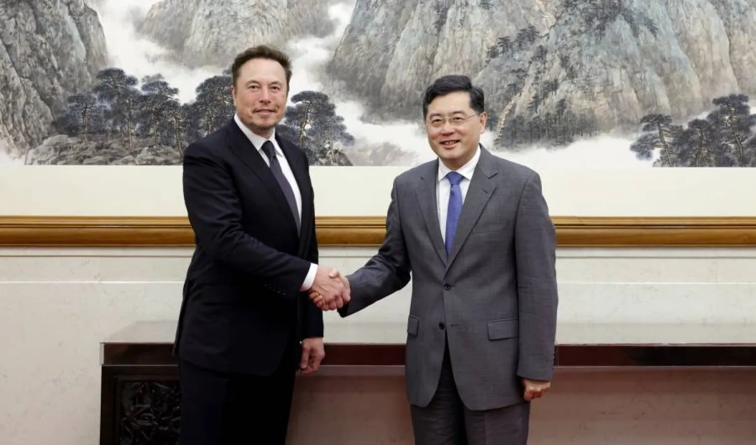 A handout photo released by the Ministry of Foreign Affairs of the People's Republic of China shows Tesla CEO Elon Musk (L) shaking hands with China's Foreign Minister Qin Gang during a meeting in Beijing, China, 30 May 2023 (issued 31 May 2023). (EPA/China Foreign Ministry handout) 
