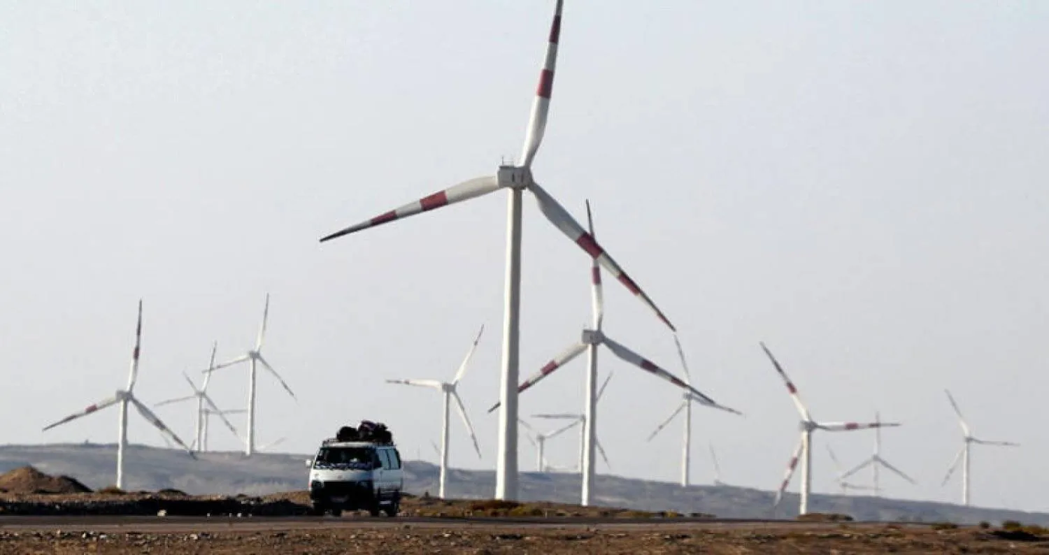 A microbus passes between giant blades to generate electricity with the wind in the Egyptian Red Sea Governorate. (Reuters) 