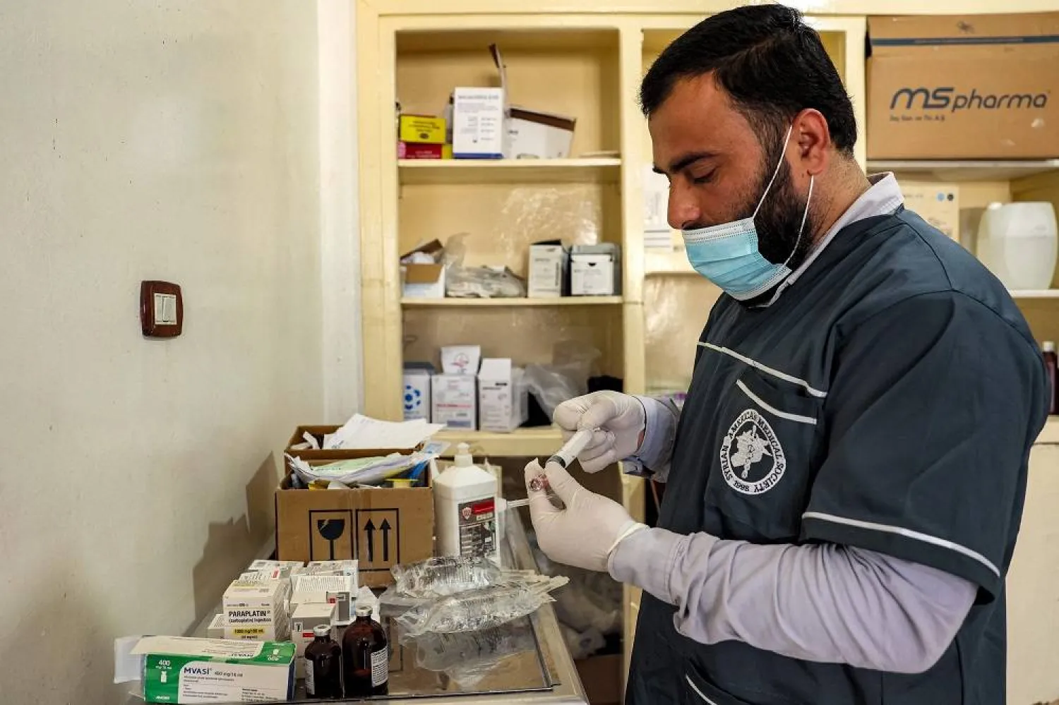 In this picture taken on May 2, 2023, an orderly prepares a syringe at the Hematology and Oncology department run by the Syrian American Medical Society (SAMS) at Idlib Central Hospital in the opposition-held northwestern Syrian city. (AFP) 
