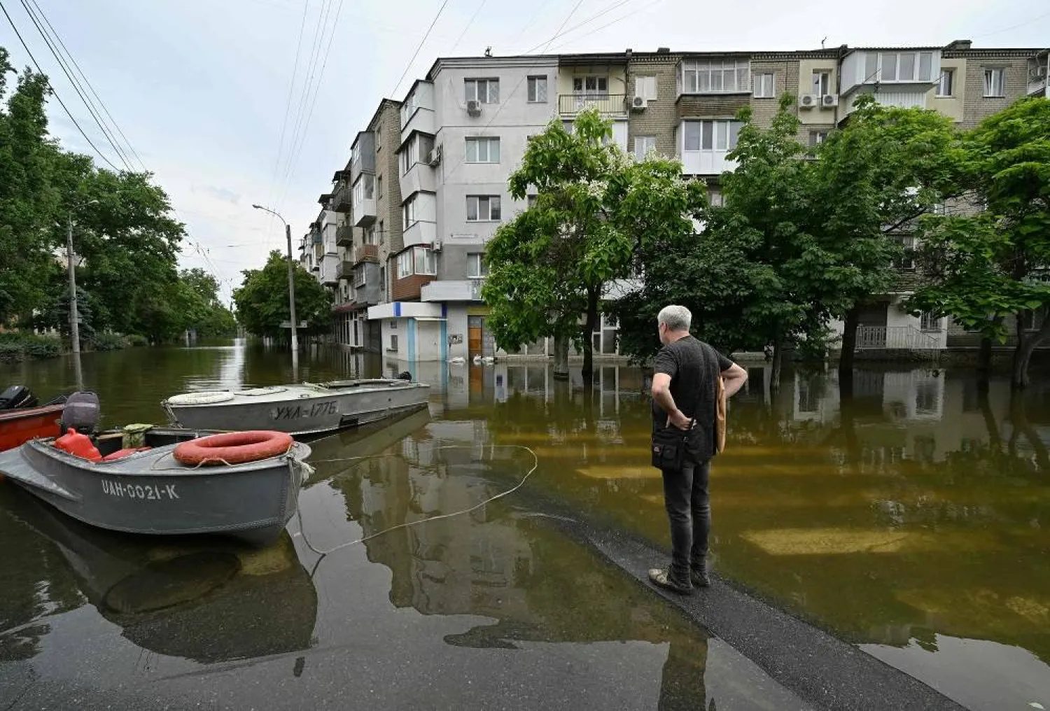 A local resident looks at a flooded street in the town of Kherson on June 10, 2023, following damages sustained at the Kakhovka hydroelectric power plant dam. (AFP) 
