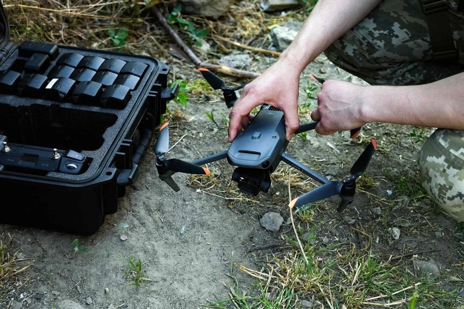 The serviceman, who identified himself by his call sign Santa, prepares to operates a commercial drone, the DJI Mavic 3, used for monitoring purposes during Ukraine's war effort, in Kherson on June 10, 2023, following damage sustained to the Kakhovka hydroelectric power plant dam in Kherson region. (AFP) 