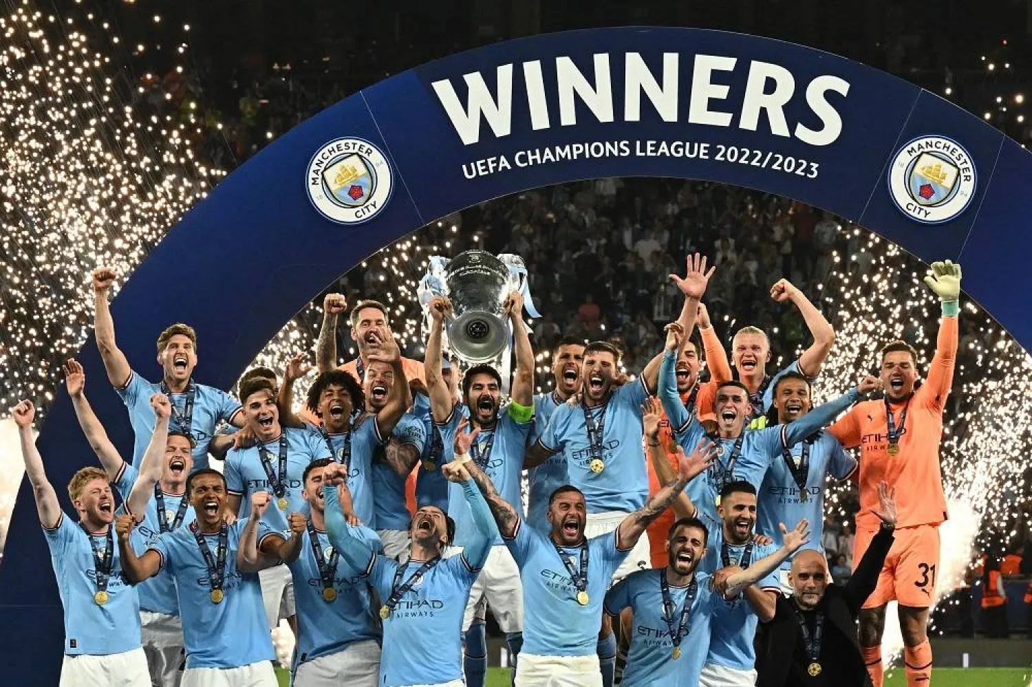 Manchester City's German midfielder #8 Ilkay Gundogan holds aloft the European Cup trophy as they celebrate winning the UEFA Champions League final football match between Inter Milan and Manchester City at the Ataturk Olympic Stadium in Istanbul, on June 10, 2023. (AFP) 