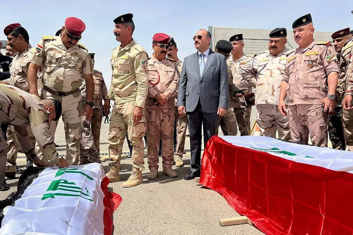 The bodies of three Iraqi soldiers who were killed in a pre-dawn attack blamed on the ISIS group, are repatriated from Kirkuk airport in northern Iraq on June 11, 2023. (AFP) 