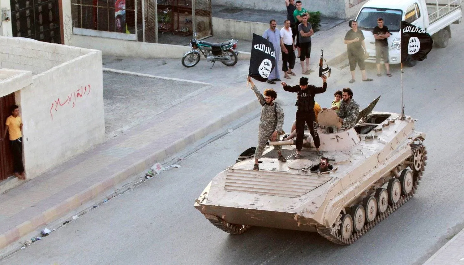 ISIS fighters after capturing the Syrian city of Raqqa on June 30, 2014 (Reuters)