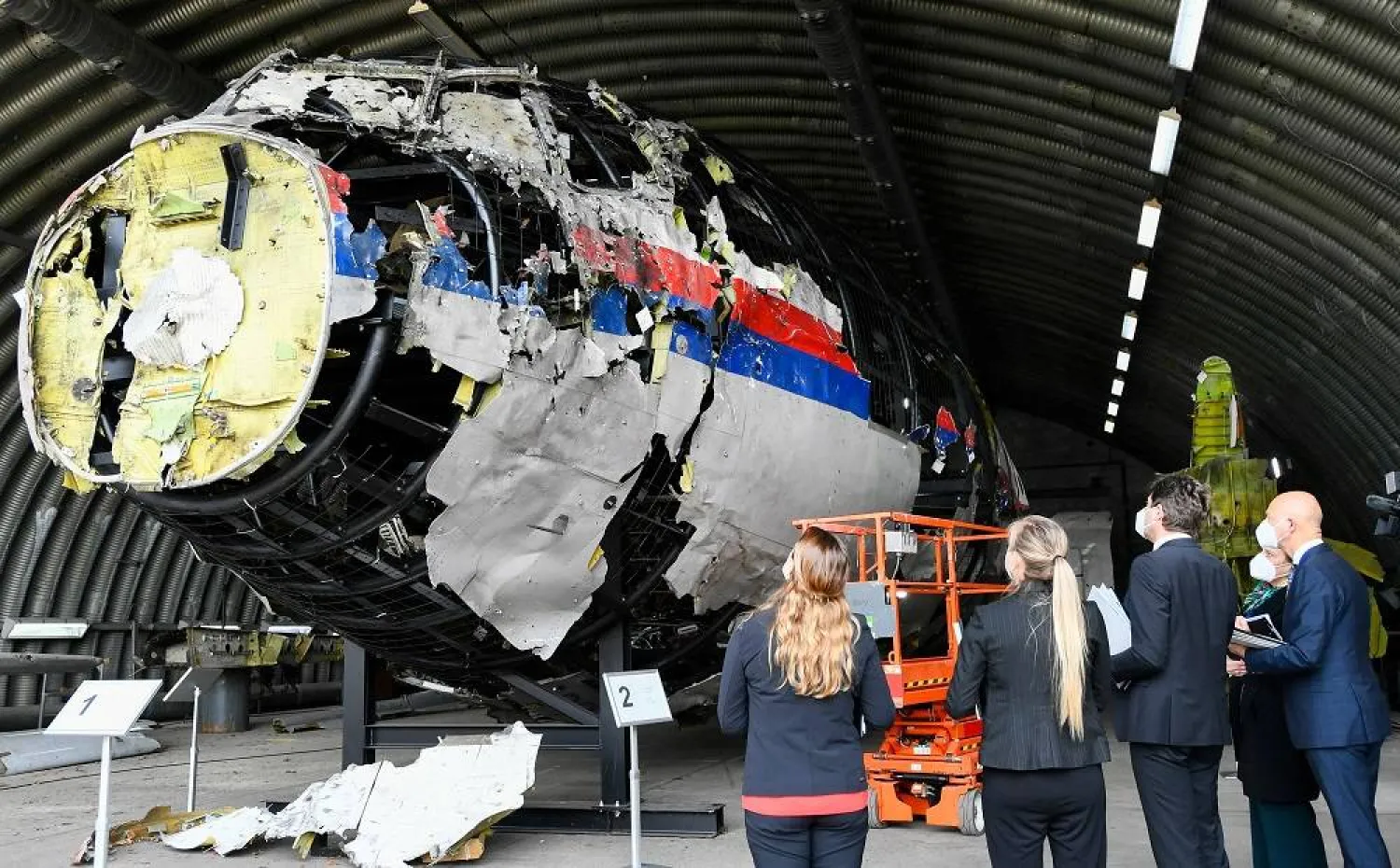 Presiding Judge Hendrik Steenhuis inspects the reconstruction of the MH17 wreckage, as part of the murder trial ahead of the beginning of a critical stage, in Reijen, Netherlands, May 26, 2021. (Reuters) 
