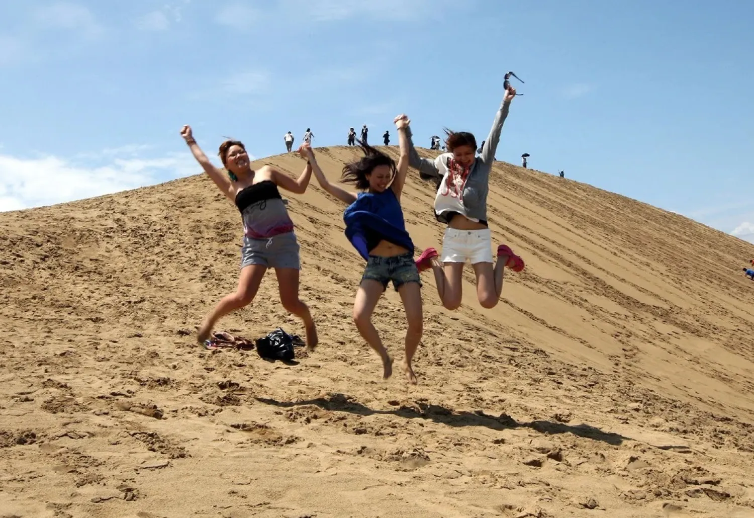 Japanese women prance on Tottori sand dunes in 2012 in Tottori.
Buddhika Weerasinghe/Getty Images