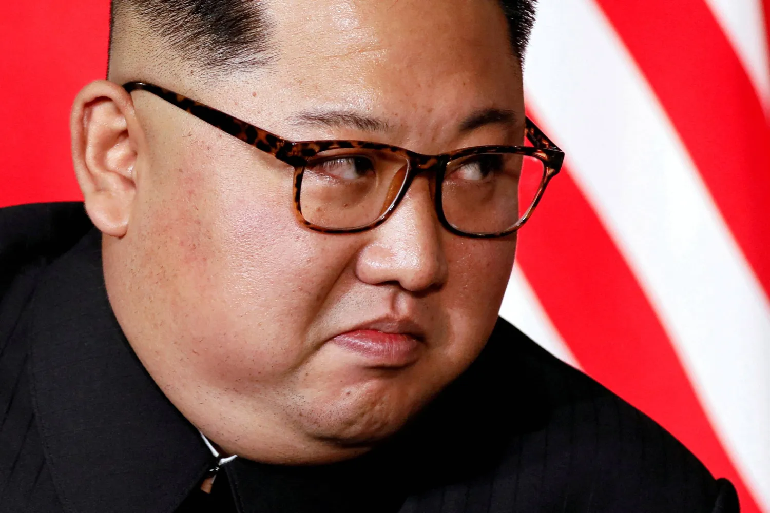 FILE PHOTO: North Korea's leader Kim Jong Un listens to US President Donald Trump as they meet in a one-on-one bilateral session at the start of their summit at the Capella Hotel on the resort island of Sentosa, Singapore June 12, 2018. Picture taken June 12, 2018. REUTERS/Jonathan Ernst//File Photo
