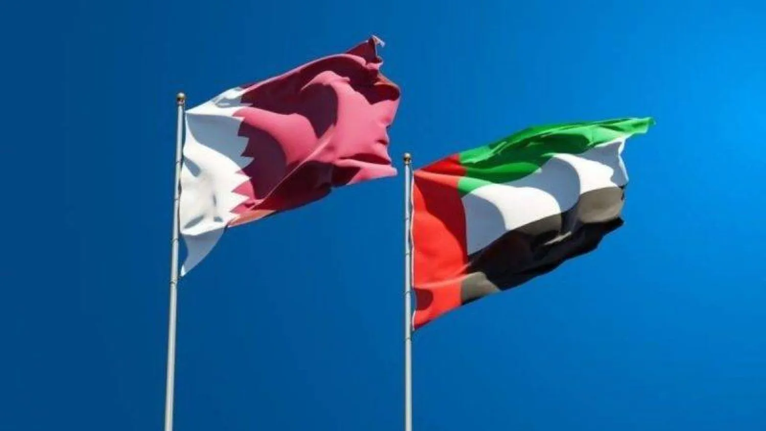 The flags of Qatar and the UAE.