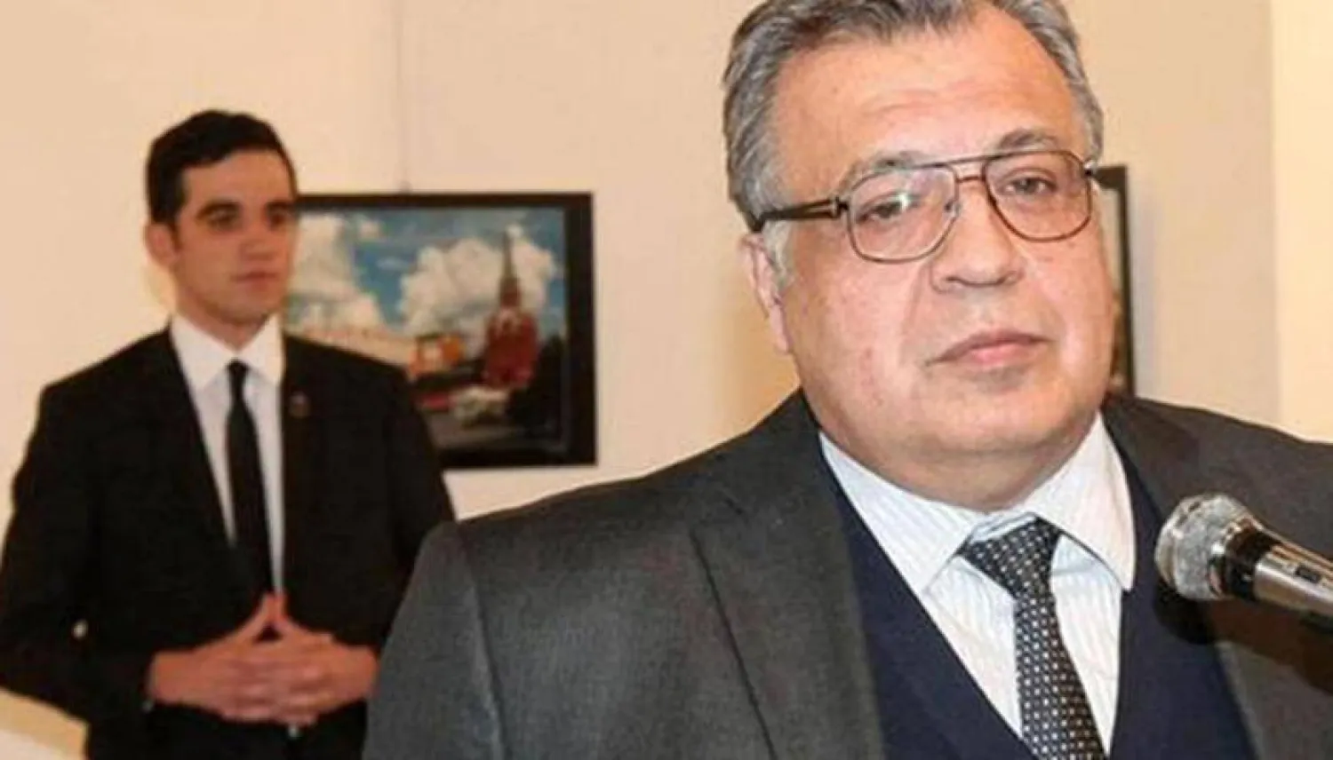 السفير الروسي الراحل أندريه كارلوف قبل لحظات من اغتياله ويبدو خلفه قاتله الضابط مولود مارت ألطنطاش (صورة أرشيفية)