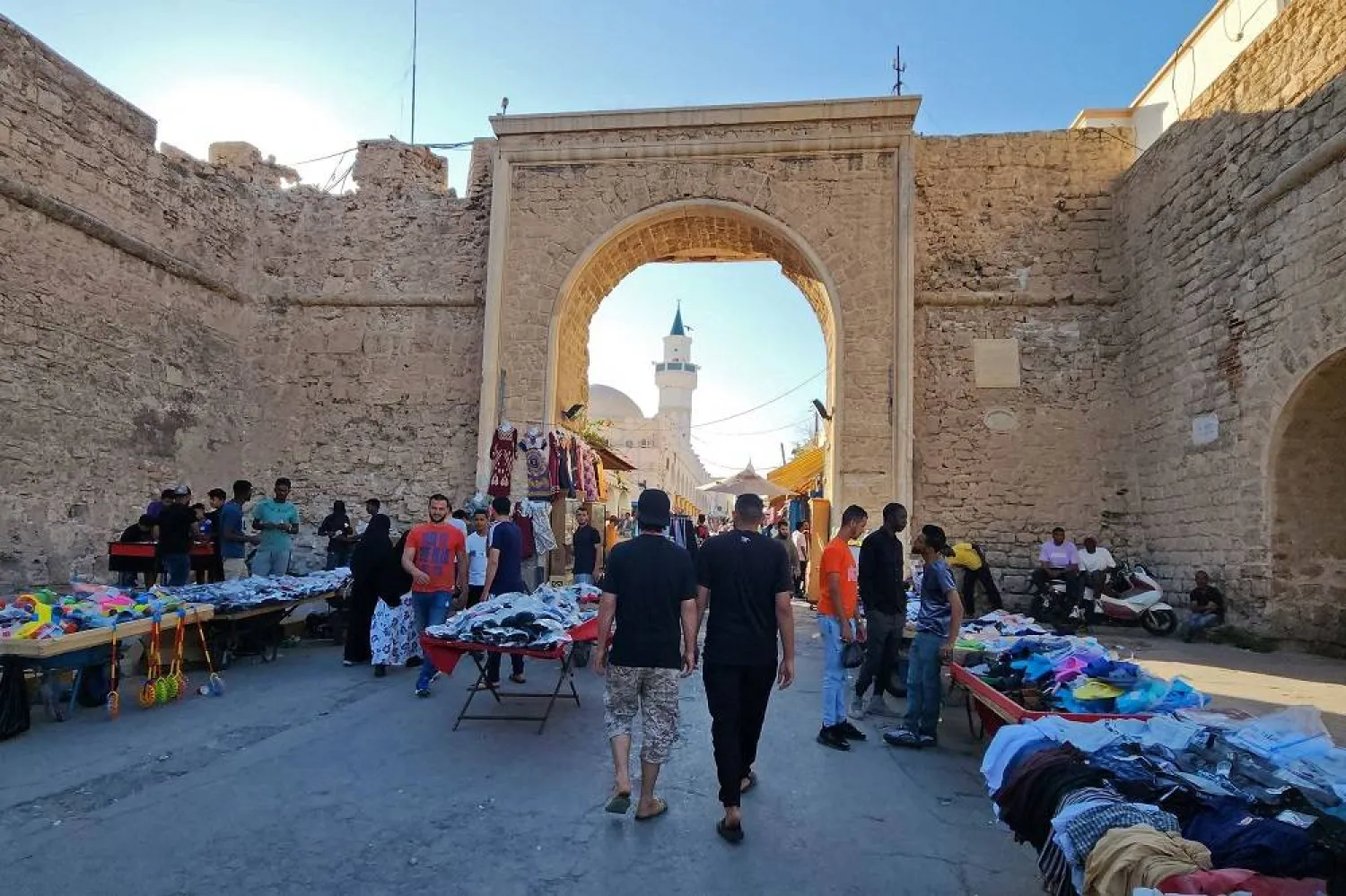 People shop at a market in the old town of the Libyan capital Tripoli on June 18, 2023. (AFP)