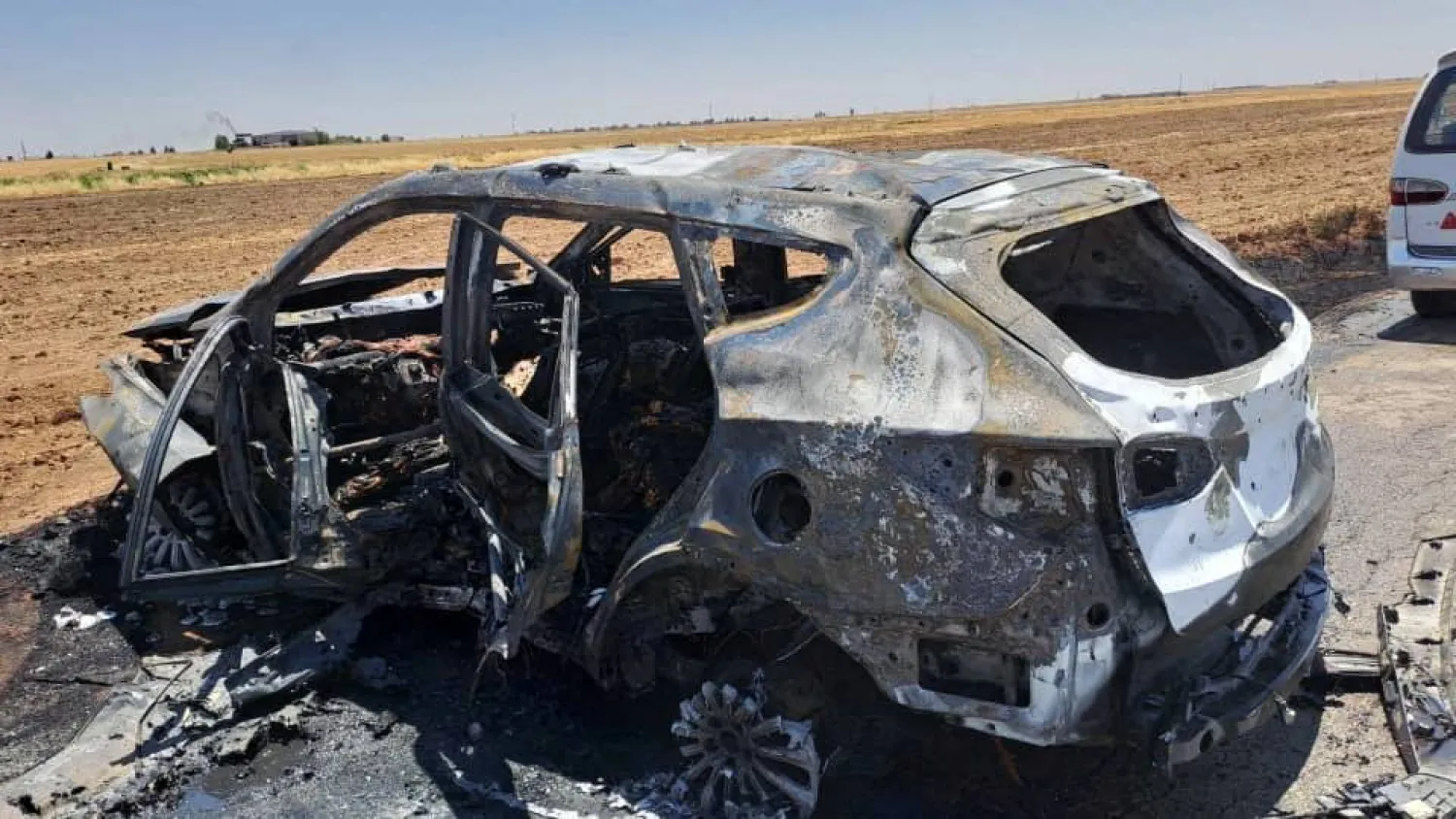 A burnt vehicle is pictured after, what medical and security sources say, was targeted by a Turkish drone strike in the village of Tal Shaeer, Syria June 20, 2023. (HAWARNEWS/Handout via Reuters) 