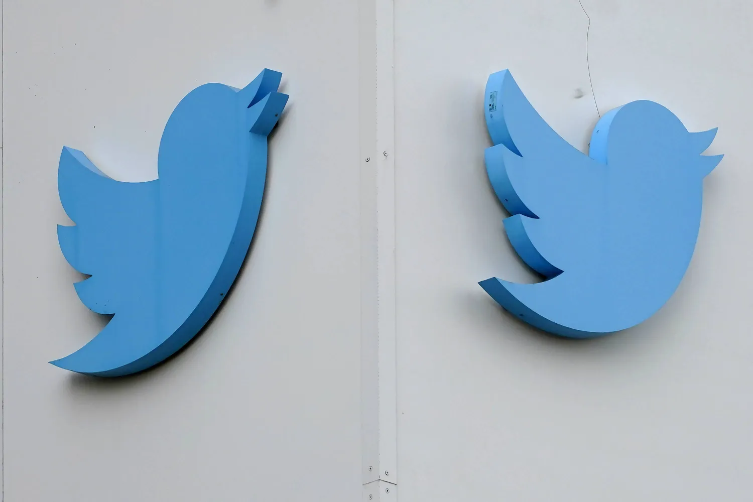 FILE - Twitter logos hang outside the company's offices in San Francisco, on Dec. 19, 2022. (AP Photo/Jeff Chiu, File)