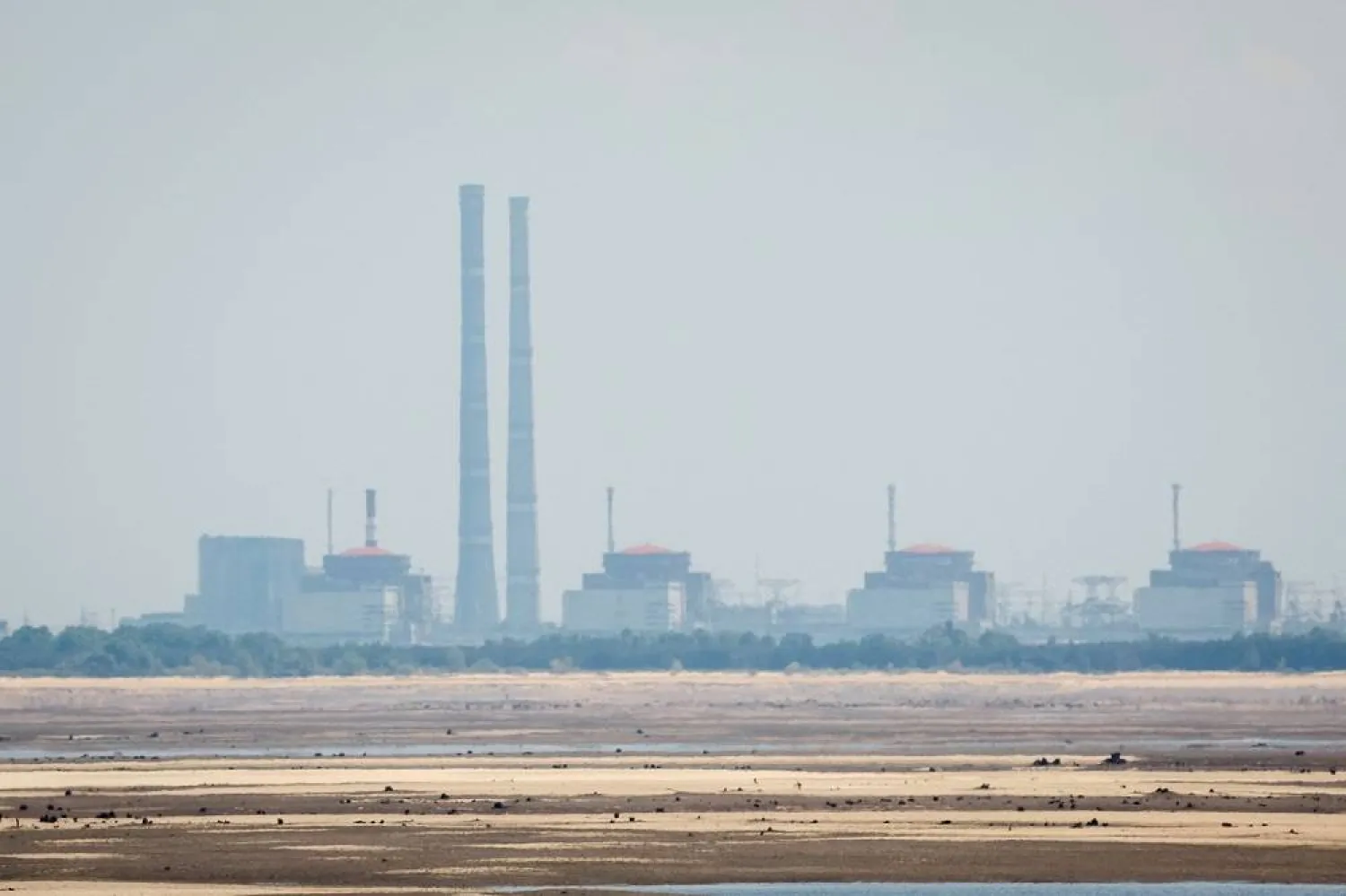 A view shows Zaporizhzhia Nuclear Power Plant from the bank of Kakhovka Reservoir near the town of Nikopol after the Nova Kakhovka dam breached, amid Russia's attack on Ukraine, in Dnipropetrovsk region, Ukraine June 16, 2023. (Reuters) 