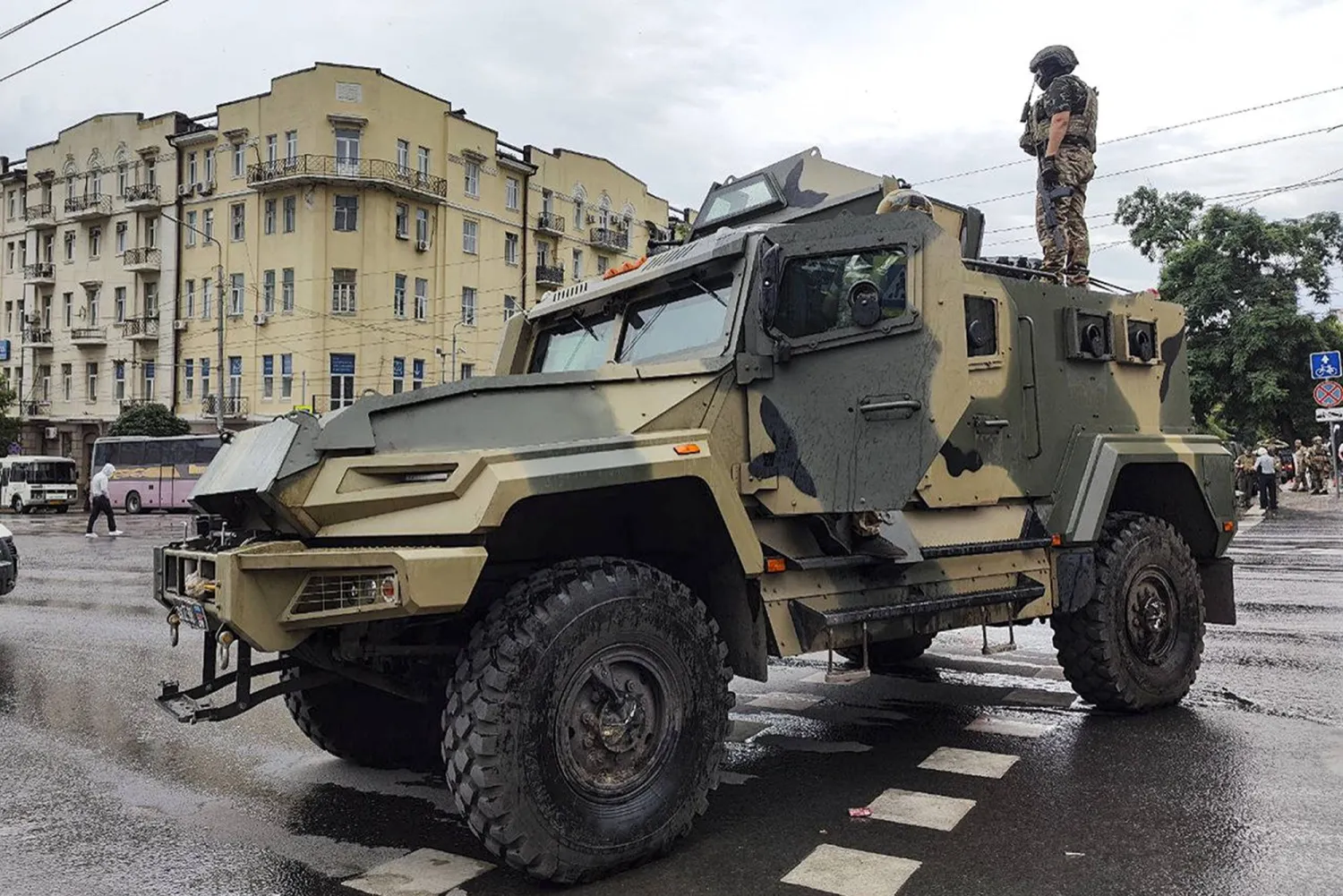 A serviceman stands atop of an armored vehicle of the Wagner Group military company, as he guards an area at the HQ of the Southern Military District in a street in Rostov-on-Don, Russia, Saturday, June 24, 2023. (AP Photo)