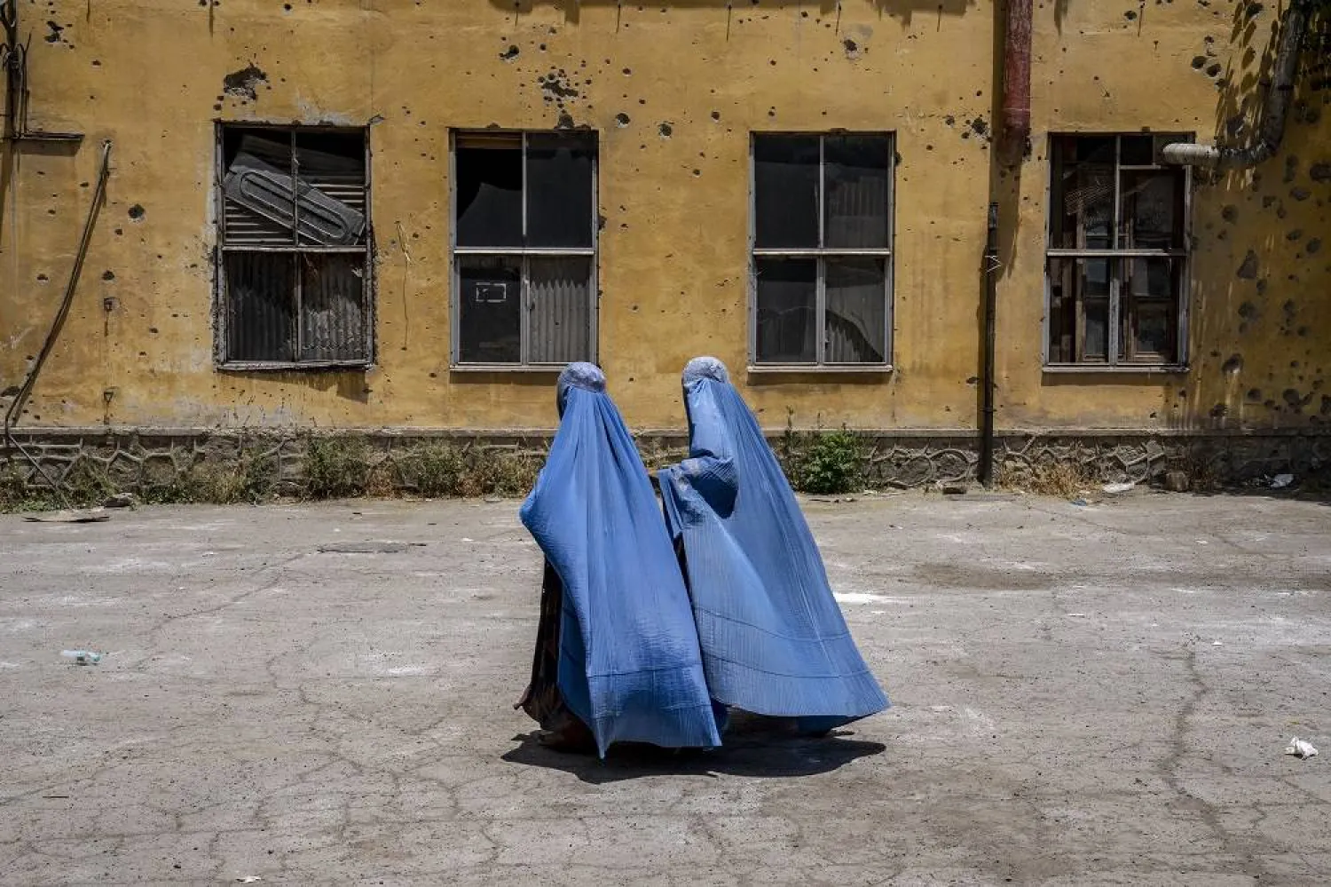 Afghan women wait to receive food rations distributed by a humanitarian aid group, in Kabul, Afghanistan, on May 28, 2023. (AP)
