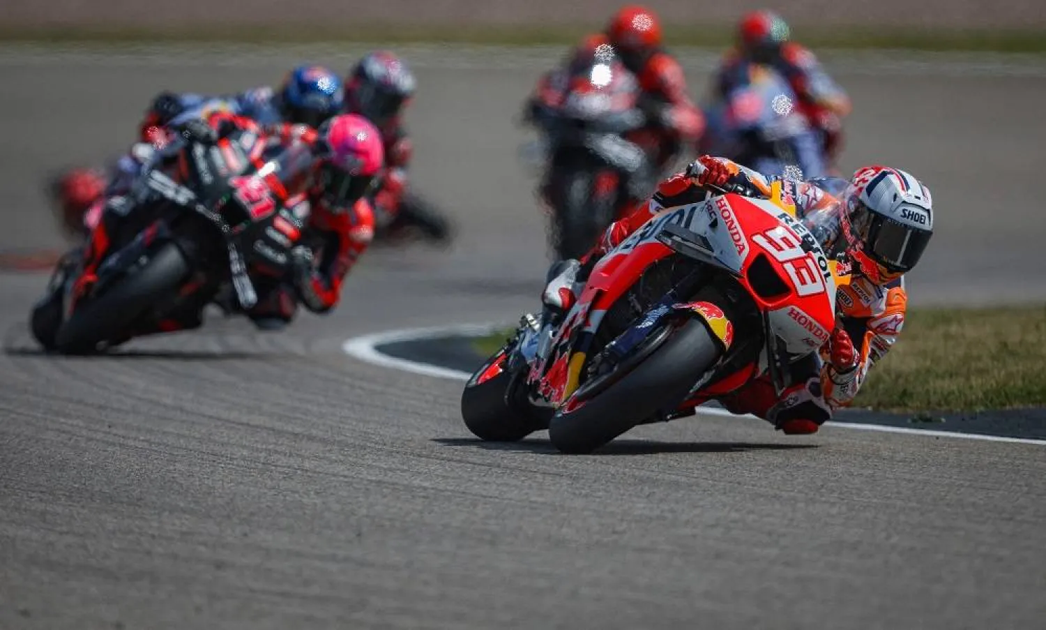 Repsol Honda Team's Spanish rider Marc Marquez (R) competes during the Sprint race of the MotoGP German motorcycle Grand Prix at the Sachsenring racing circuit in Hohenstein-Ernstthal near Chemnitz, eastern Germany, on June 17, 2023. (AFP) 