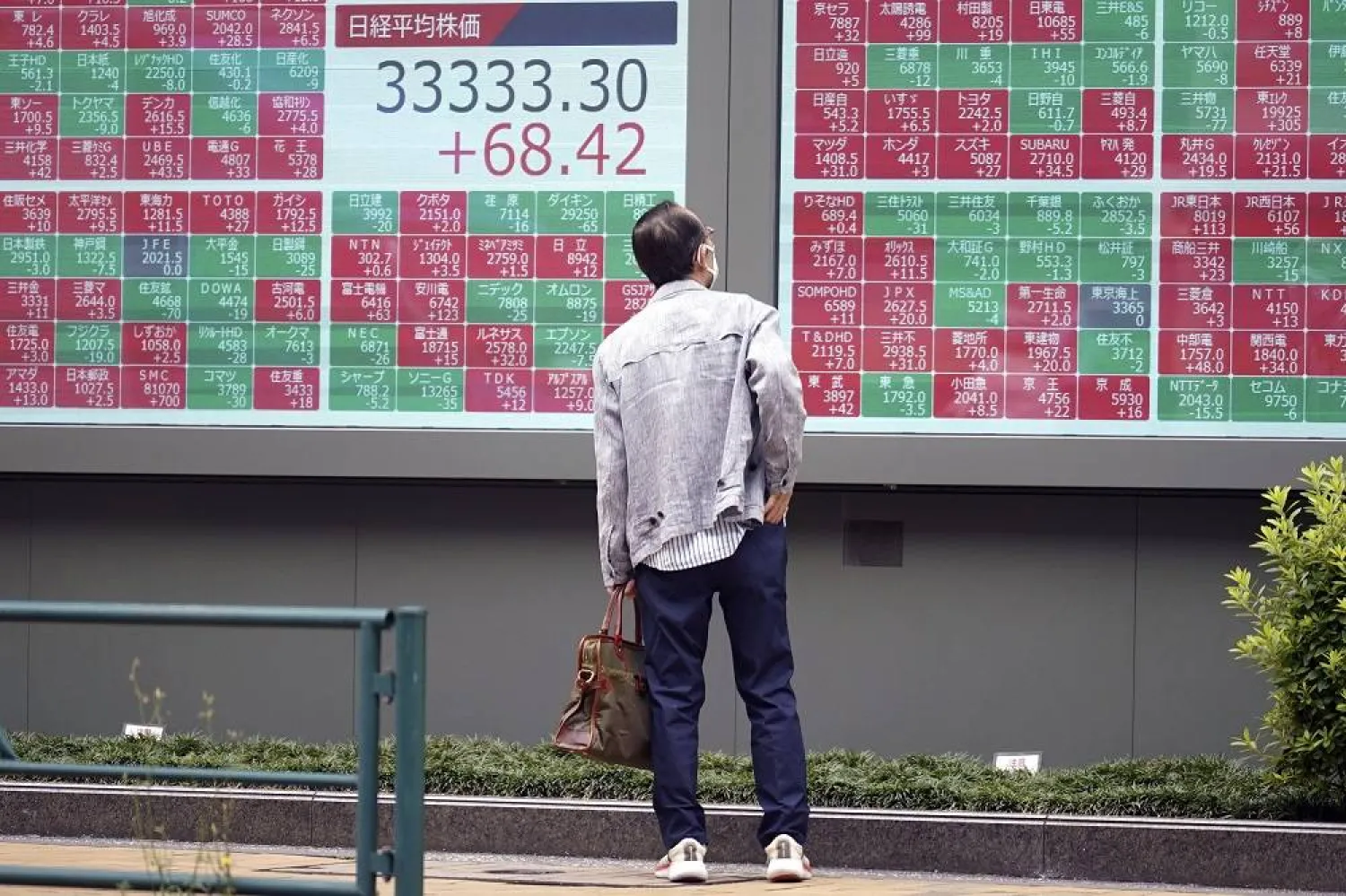 A person looks at an electronic stock board showing Japan's Nikkei 225 index at a securities firm Friday, June 23, 2023, in Tokyo. (AP)