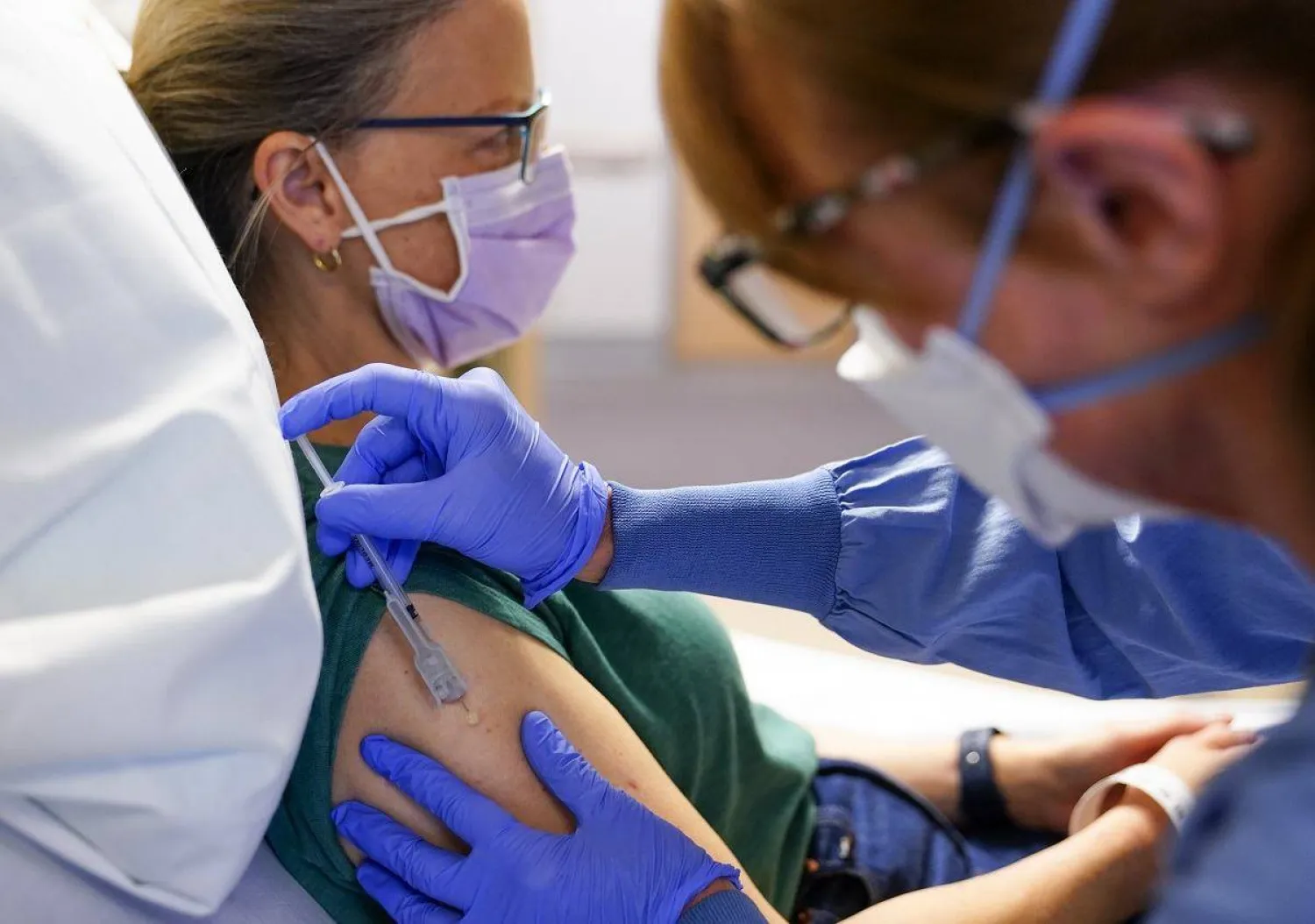 AP Photo/Lindsey Wasson- Registered nurse Erika Obrietan administers the third dose of an experimental breast cancer vaccine to patient Kathleen Jade at University of Washington Medical Center – Montlake, Tuesday, May 30, 2023, in Seattle.