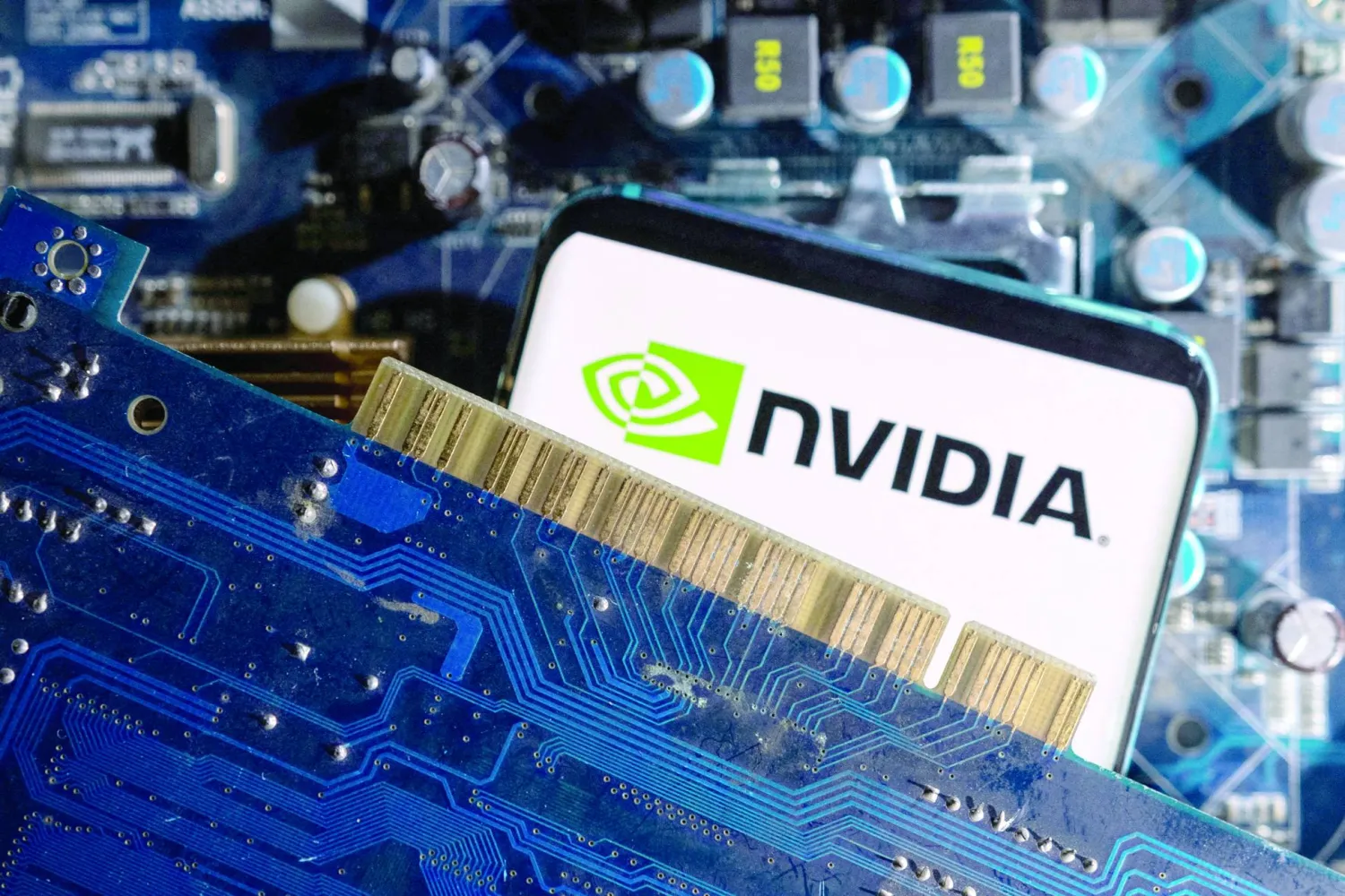 FILE PHOTO: A smartphone with a displayed NVIDIA logo is placed on a computer motherboard in this illustration taken March 6, 2023. REUTERS/Dado Ruvic/Illustration/File Photo

