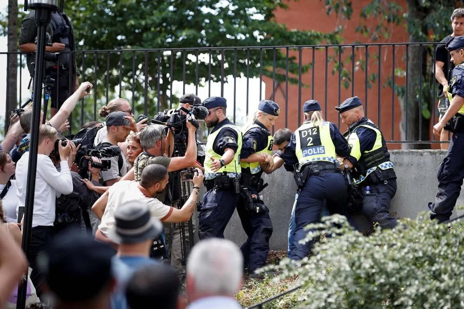 Police officers intervene after people's reaction as demonstrators burn the Quran (not pictured) outside Stockholm's Central Mosque in Stockholm, Sweden June 28, 2023. (TT News Agency/Caisa Rasmussen/via Reuters) 